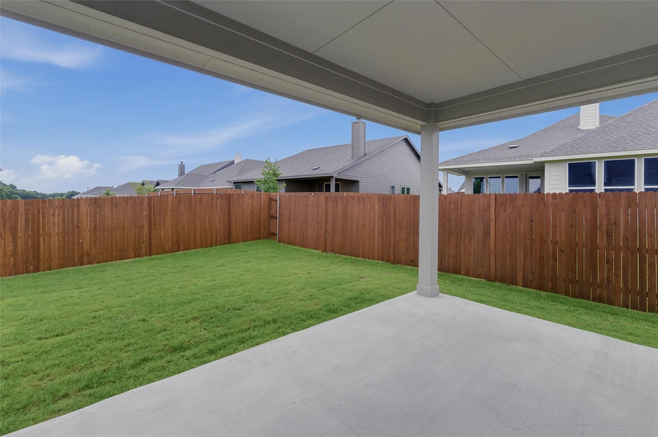 Covered patio featuring a concrete slab and support columns