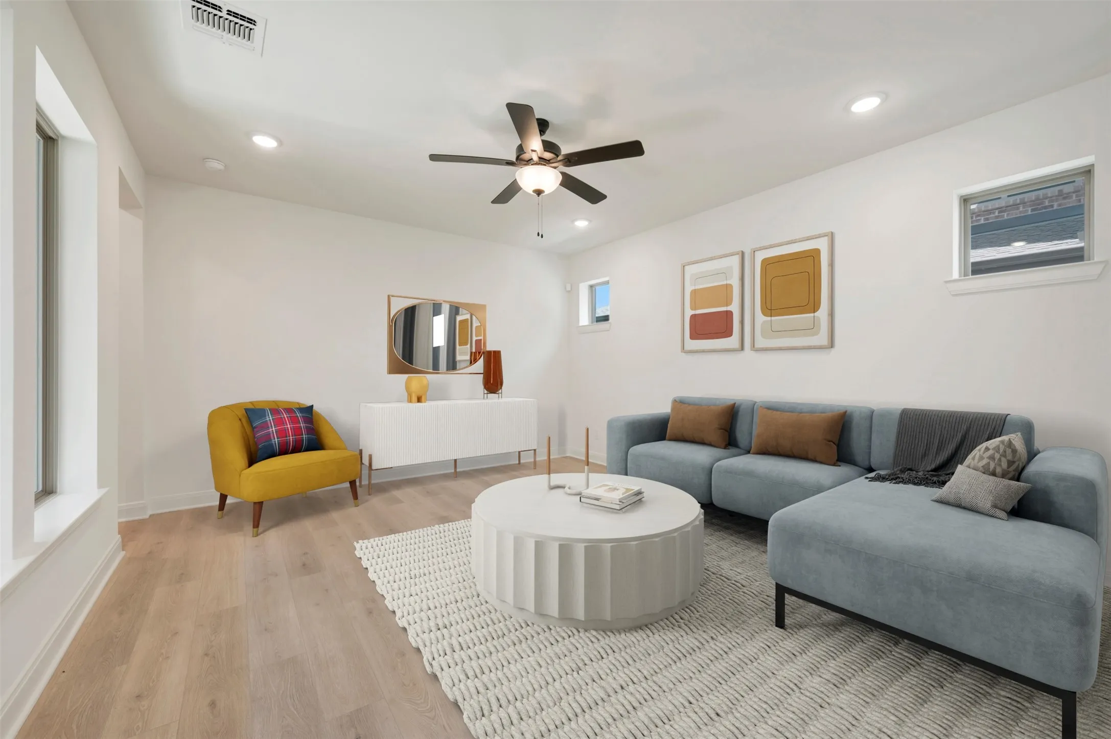 Bright living area featuring wood-finish flooring, recessed lighting, and a ceiling fan
