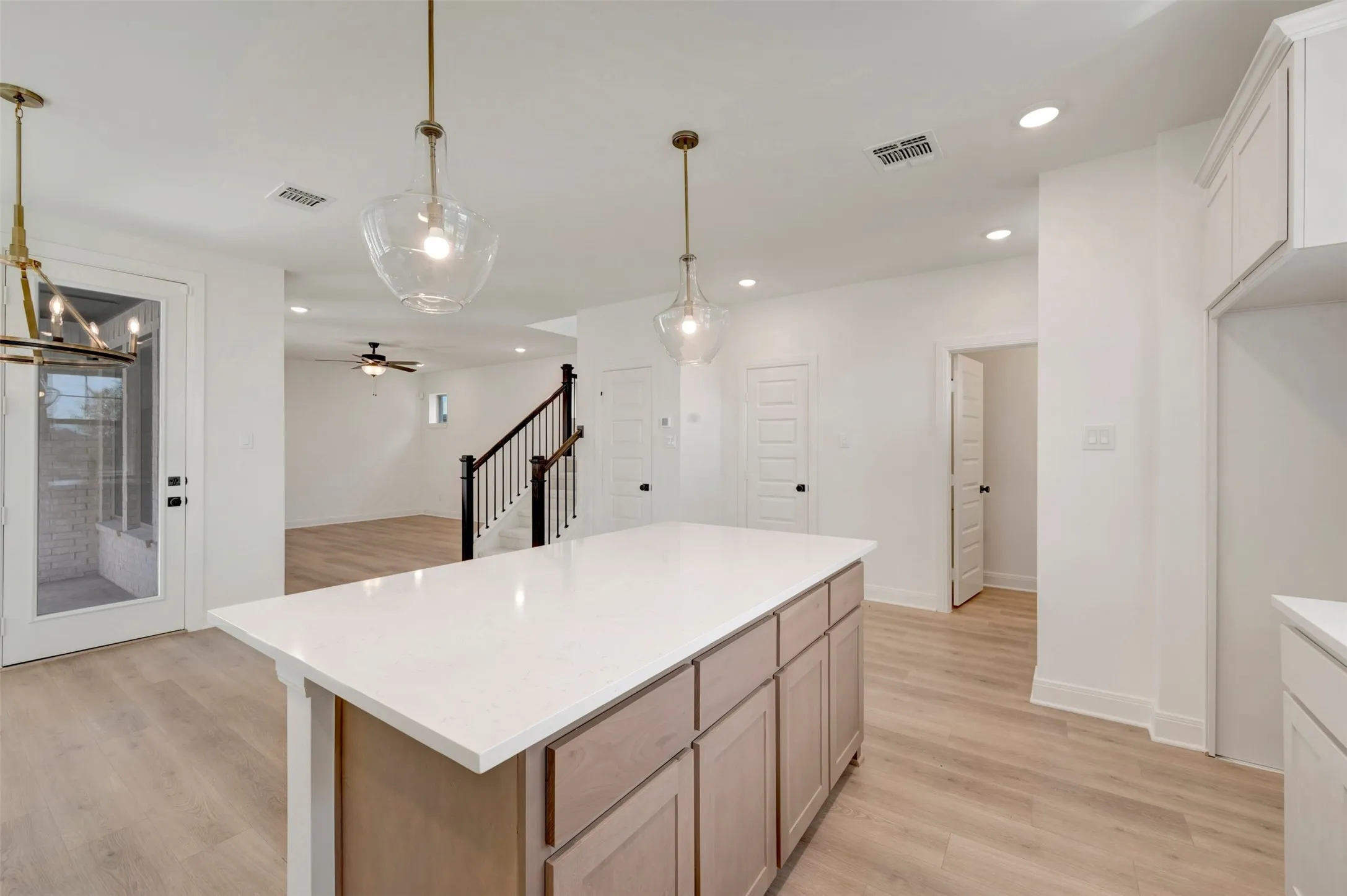 Kitchen island with a light-toned countertop and wood-finish cabinetry