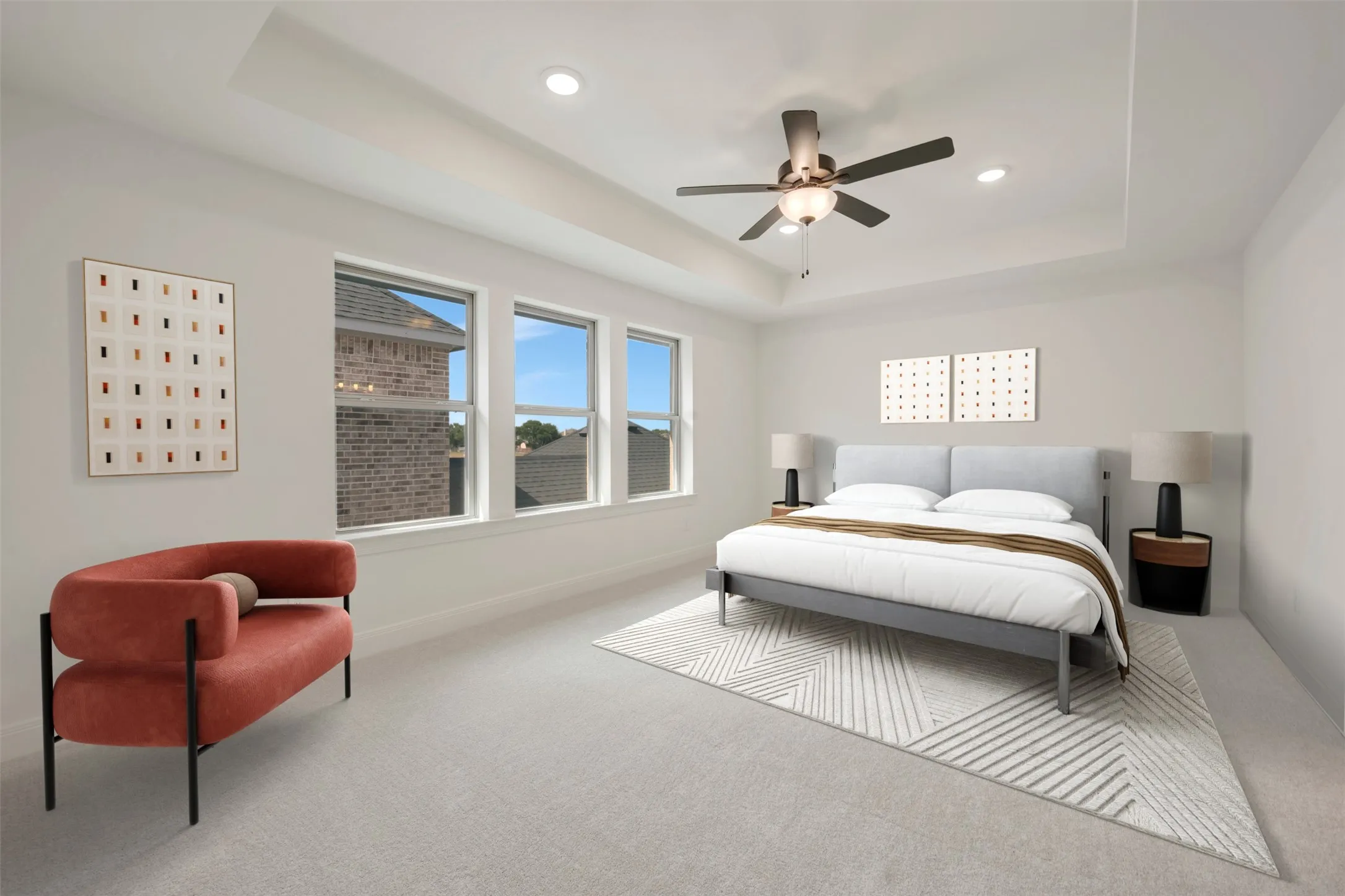 Spacious room featuring a tray ceiling with recessed lighting, a ceiling fan with integrated light fixture, and three large windows