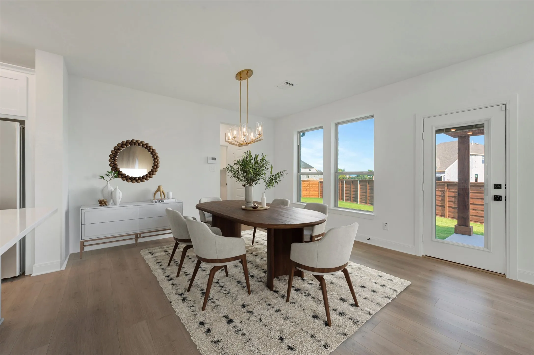 Open-concept dining area featuring wood-finish flooring