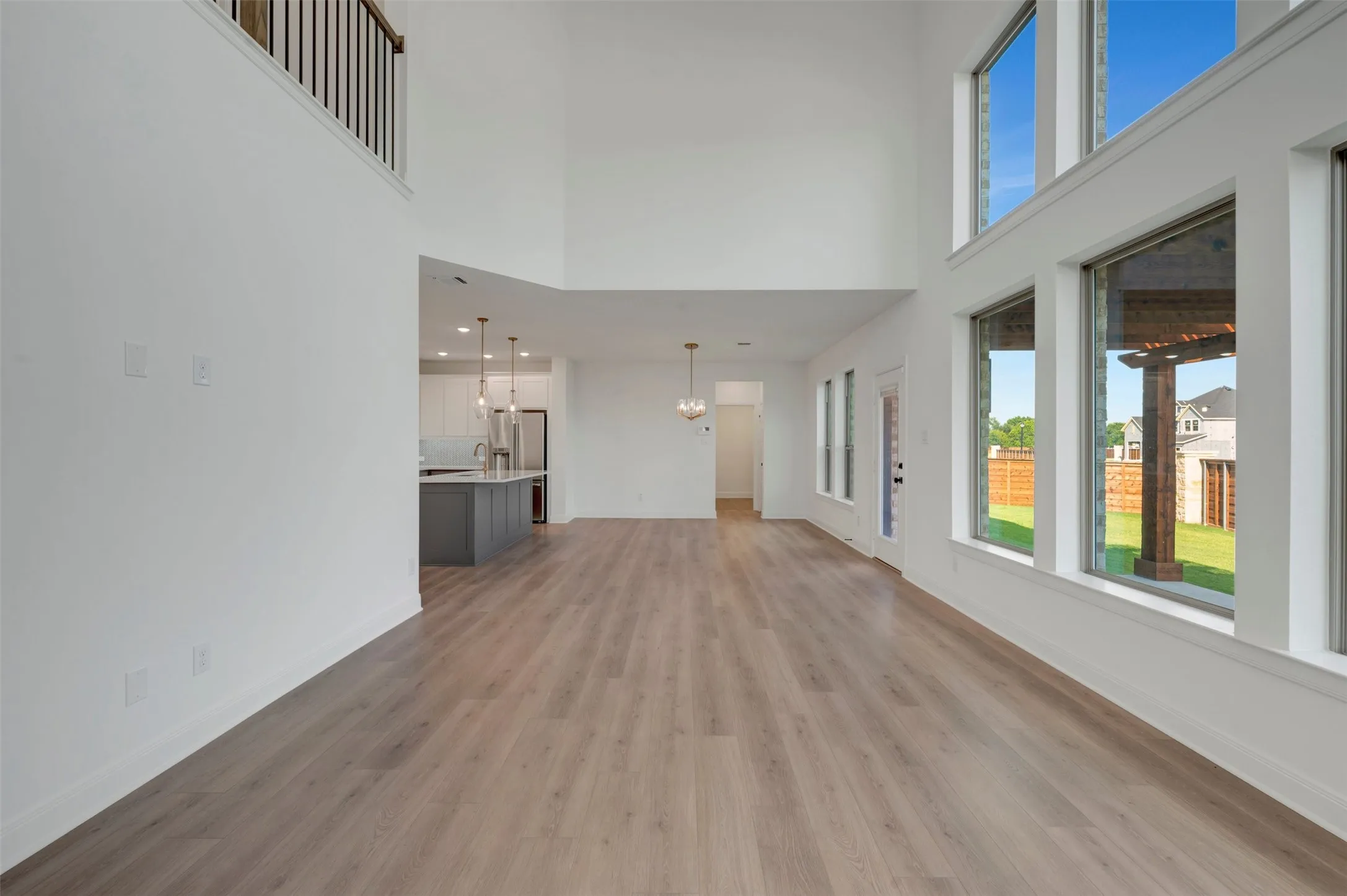 Expansive living area featuring soaring ceilings and wood-finish flooring