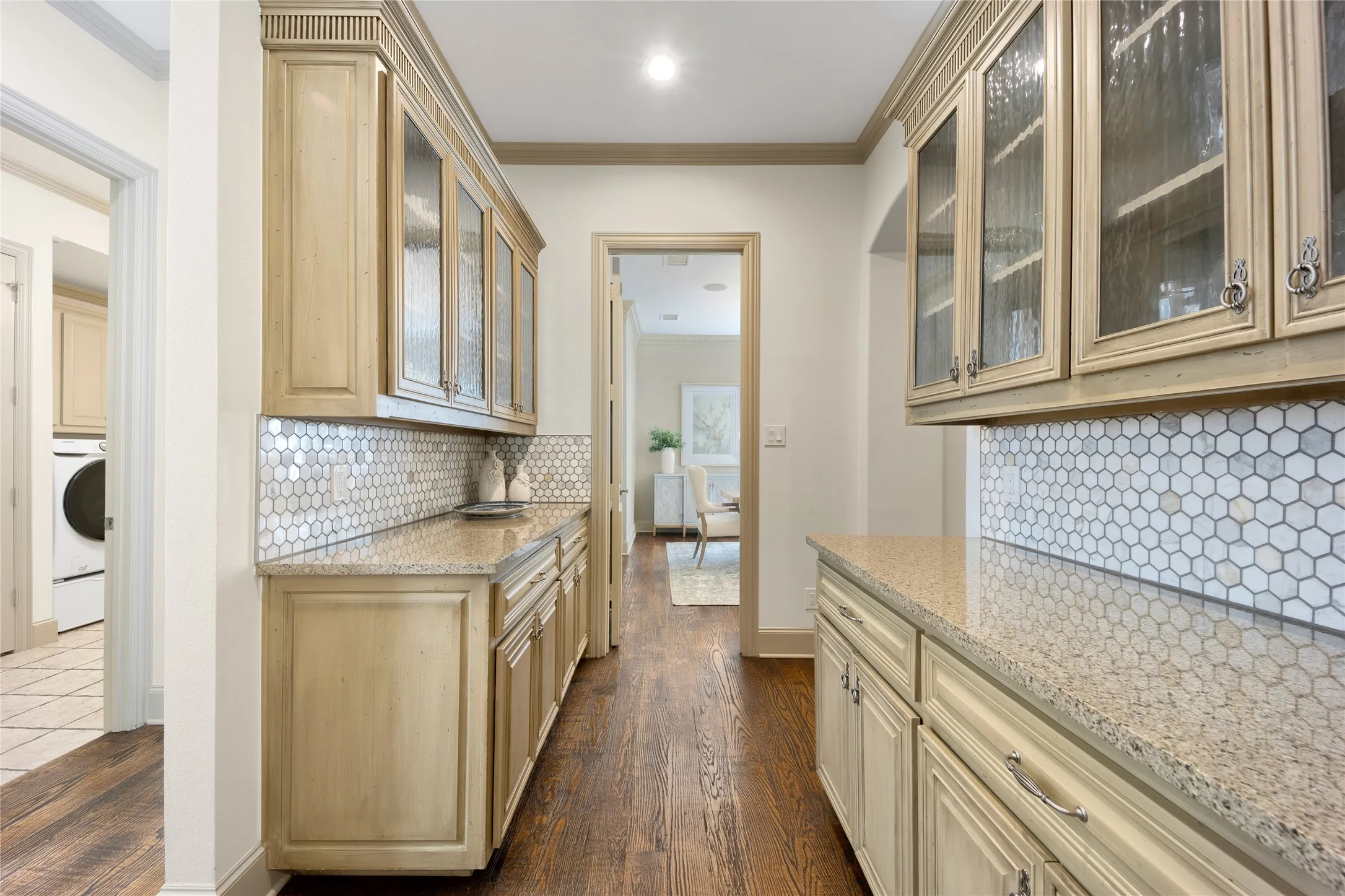 Two butler pantries service the formal dining room and lies just outside of the kitchen. This is a perfect scenario for catering access through garage and/or for buffet set up on the 2 large countertops.
