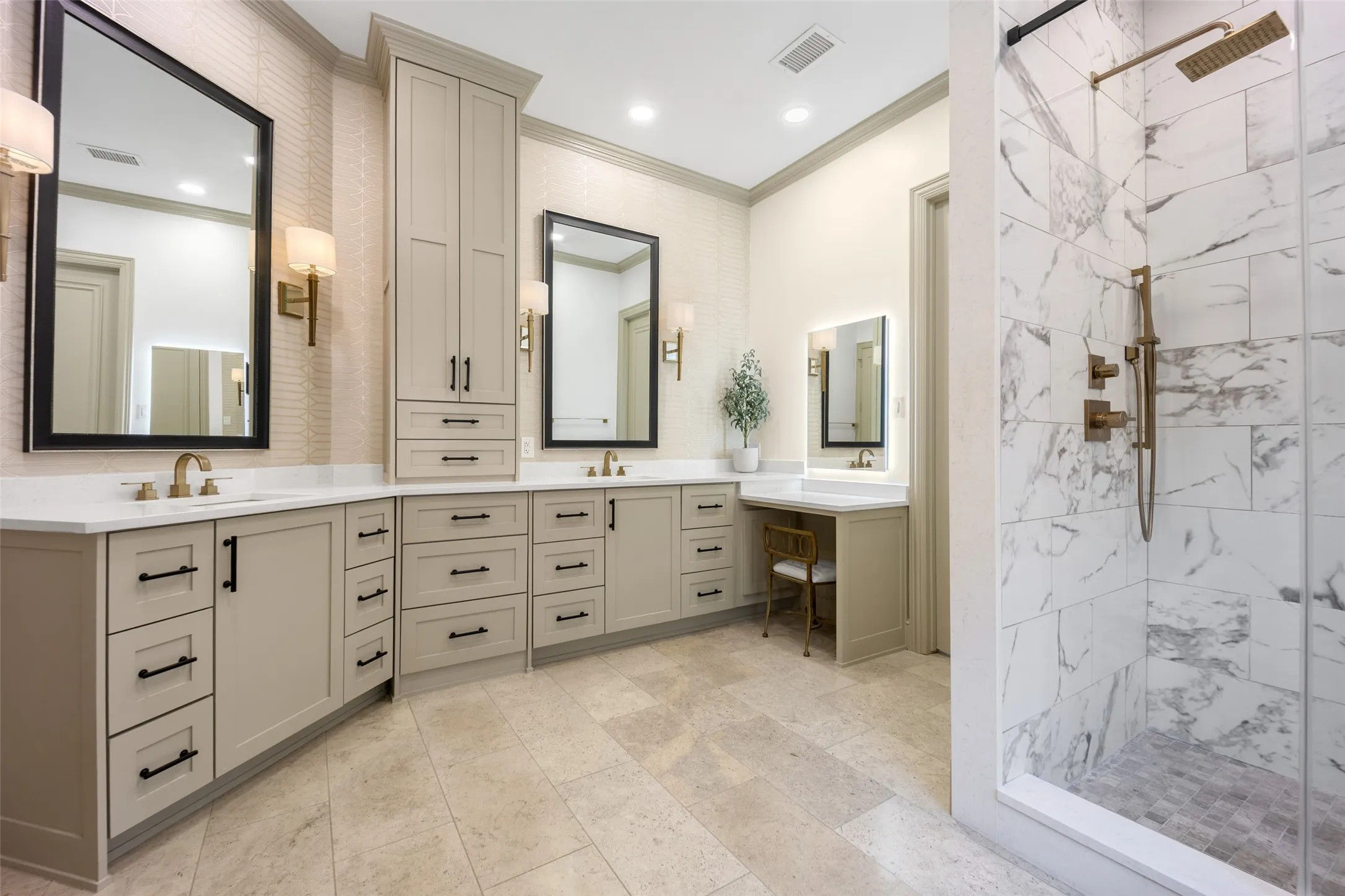 Spa-worthy primary bath has been updated with a neutral, transitional color palette. Marble shower with brass-fitted rainshower, separate soaking tub, a seated lit makeup vanity and tons of storage. A huge walk in closet lies just off the bath.