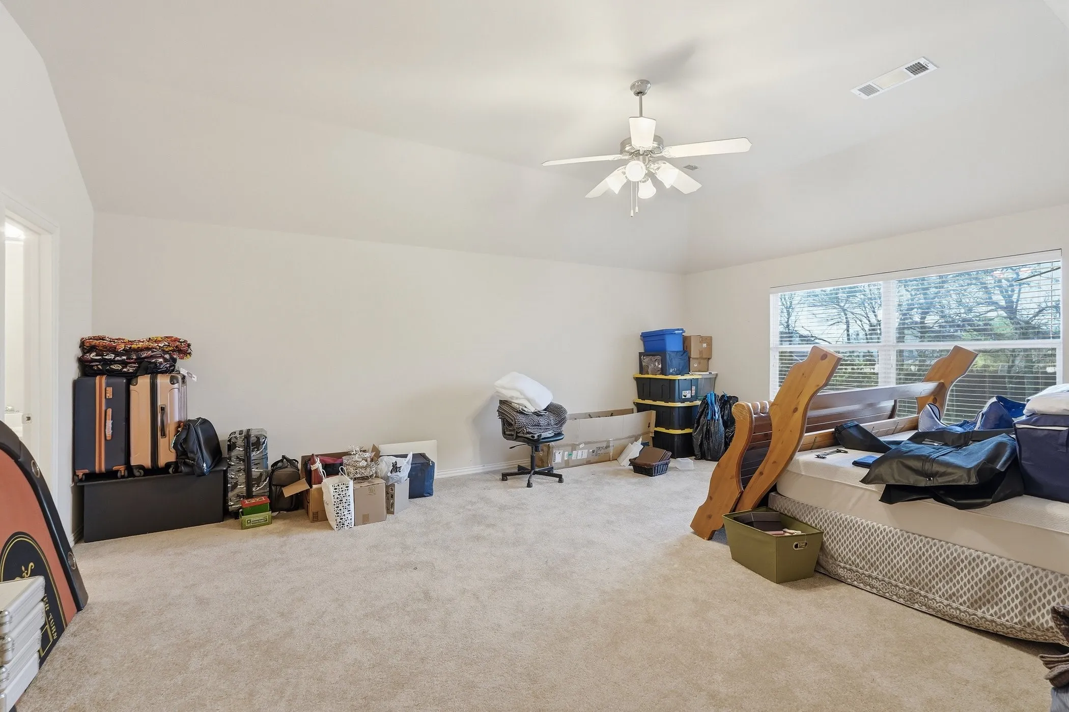Carpeted home office with lofted ceiling and a ceiling fan 2nd floor