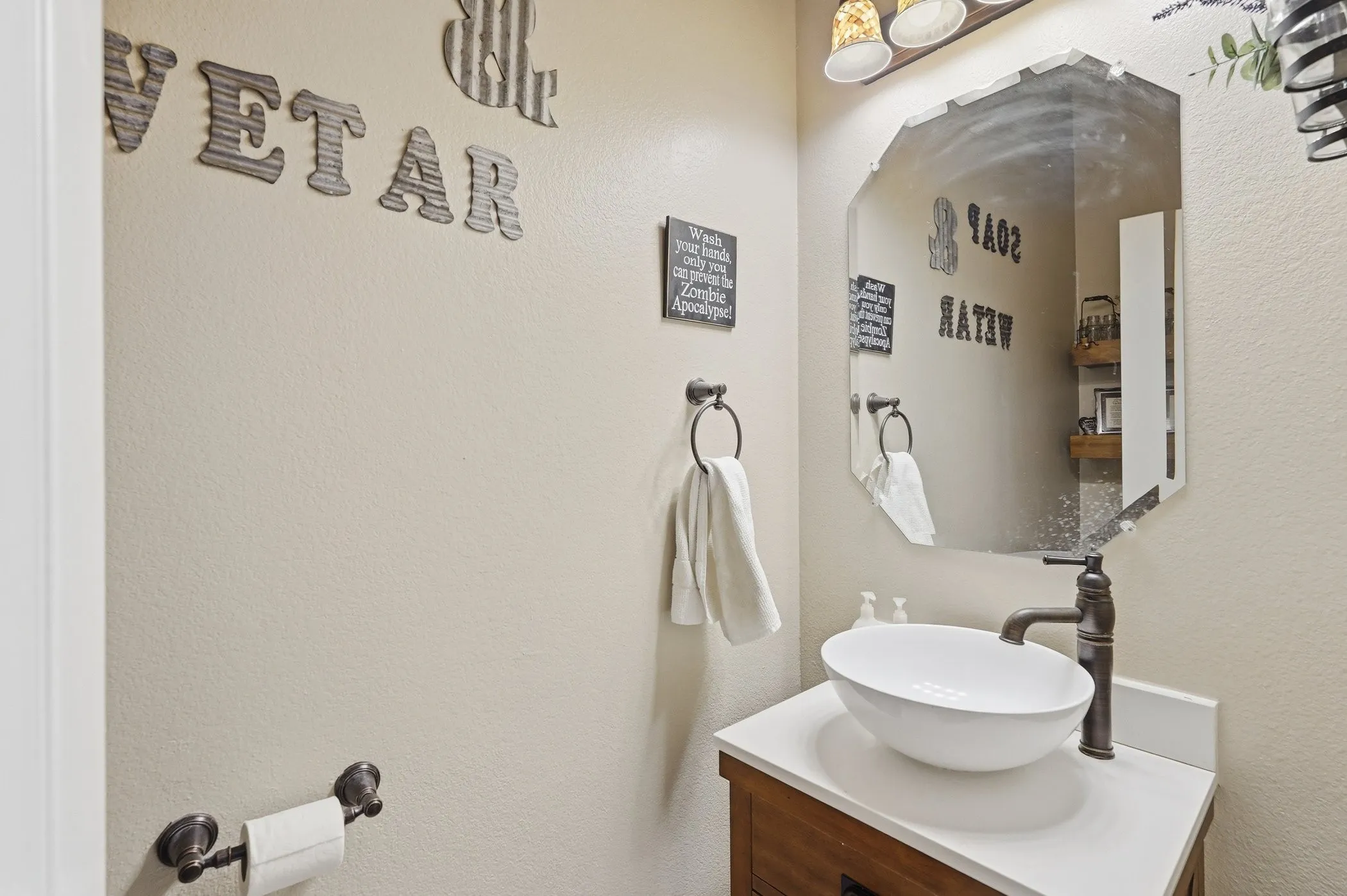 Bathroom with vanity and a textured wall