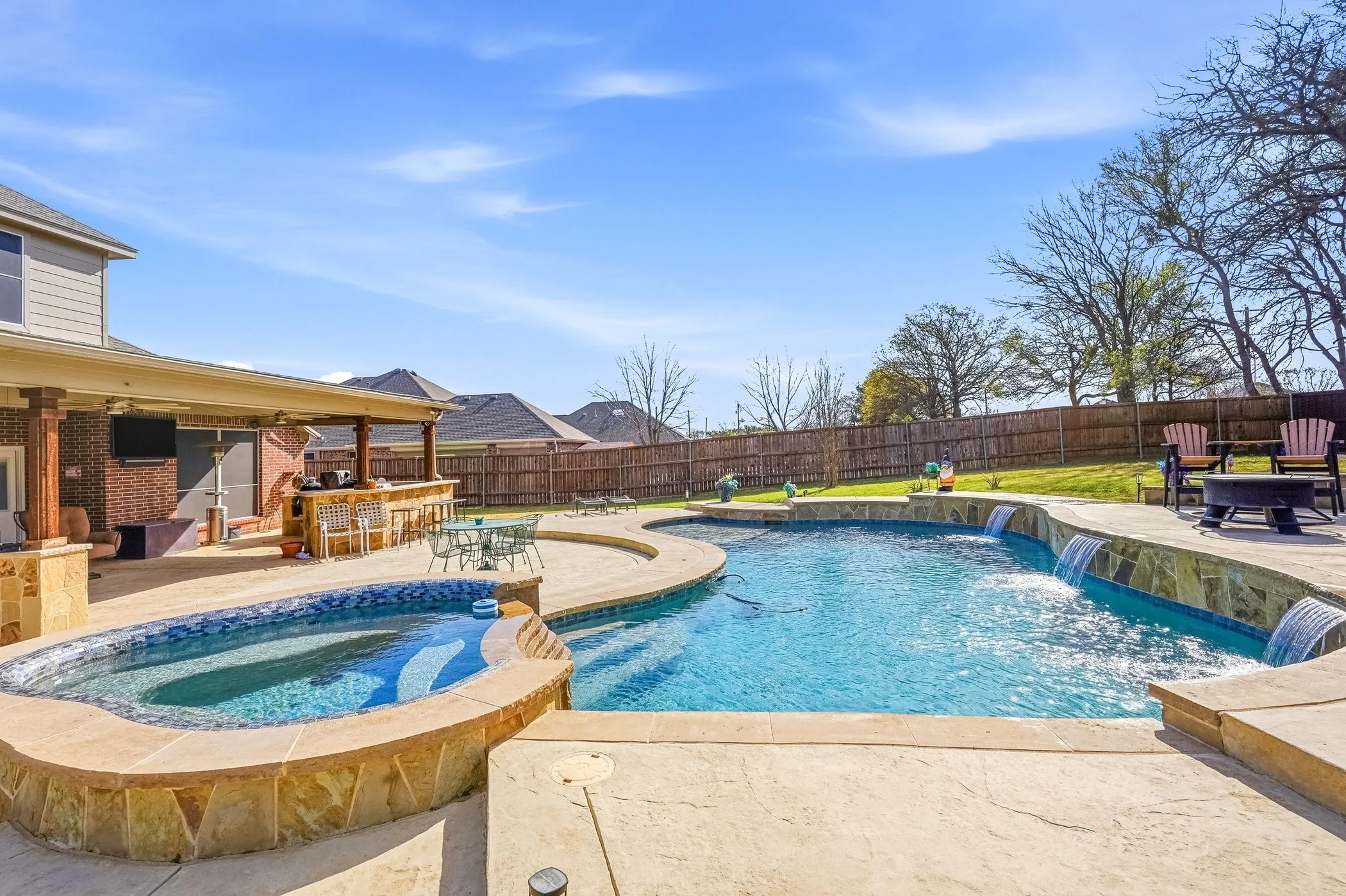 Salt water pool / hot tub with a patio, a fenced backyard, and a fire pit