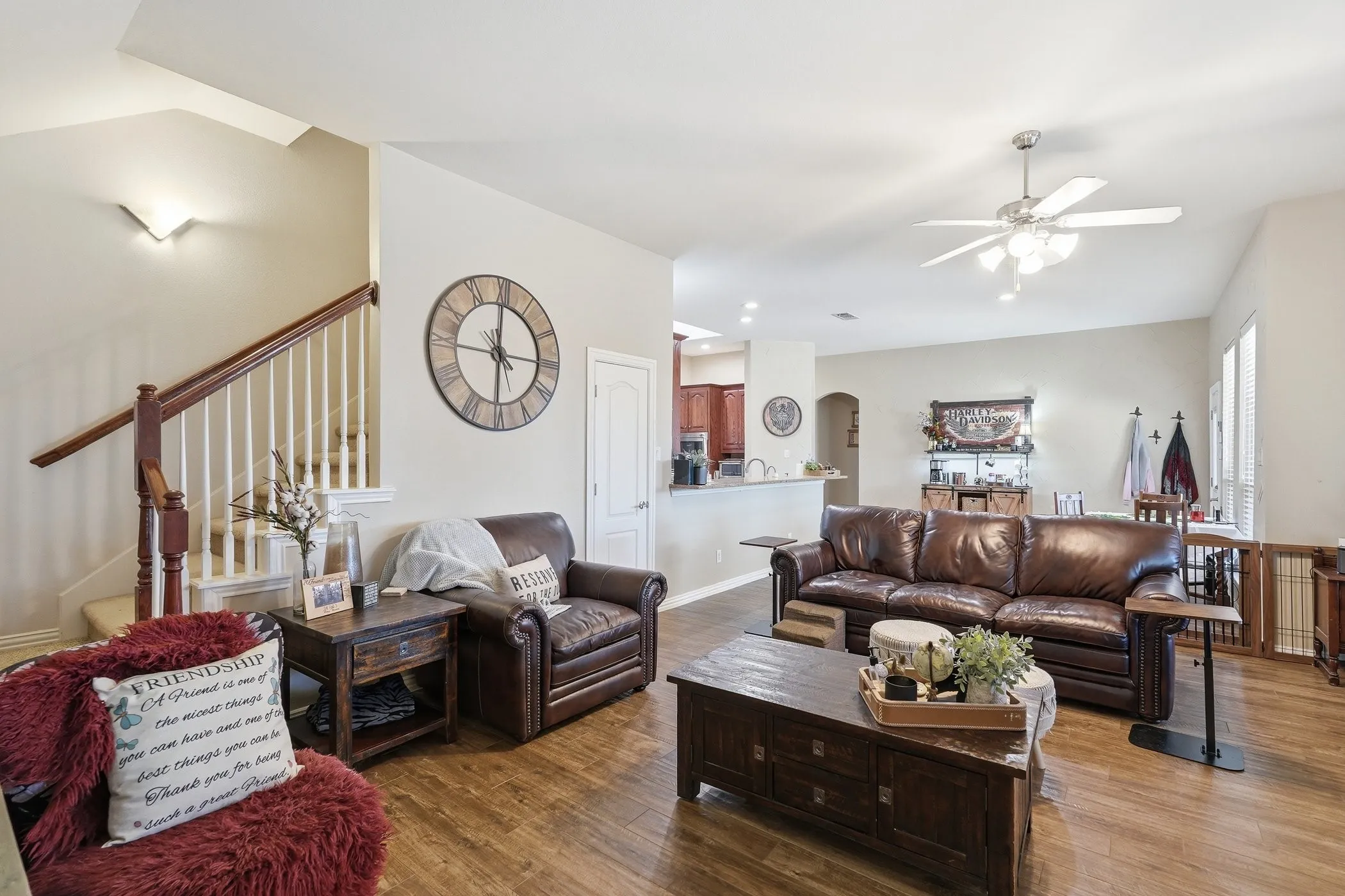 Living room featuring ceiling fan, wood finished floors, arched walkways, and recessed lighting