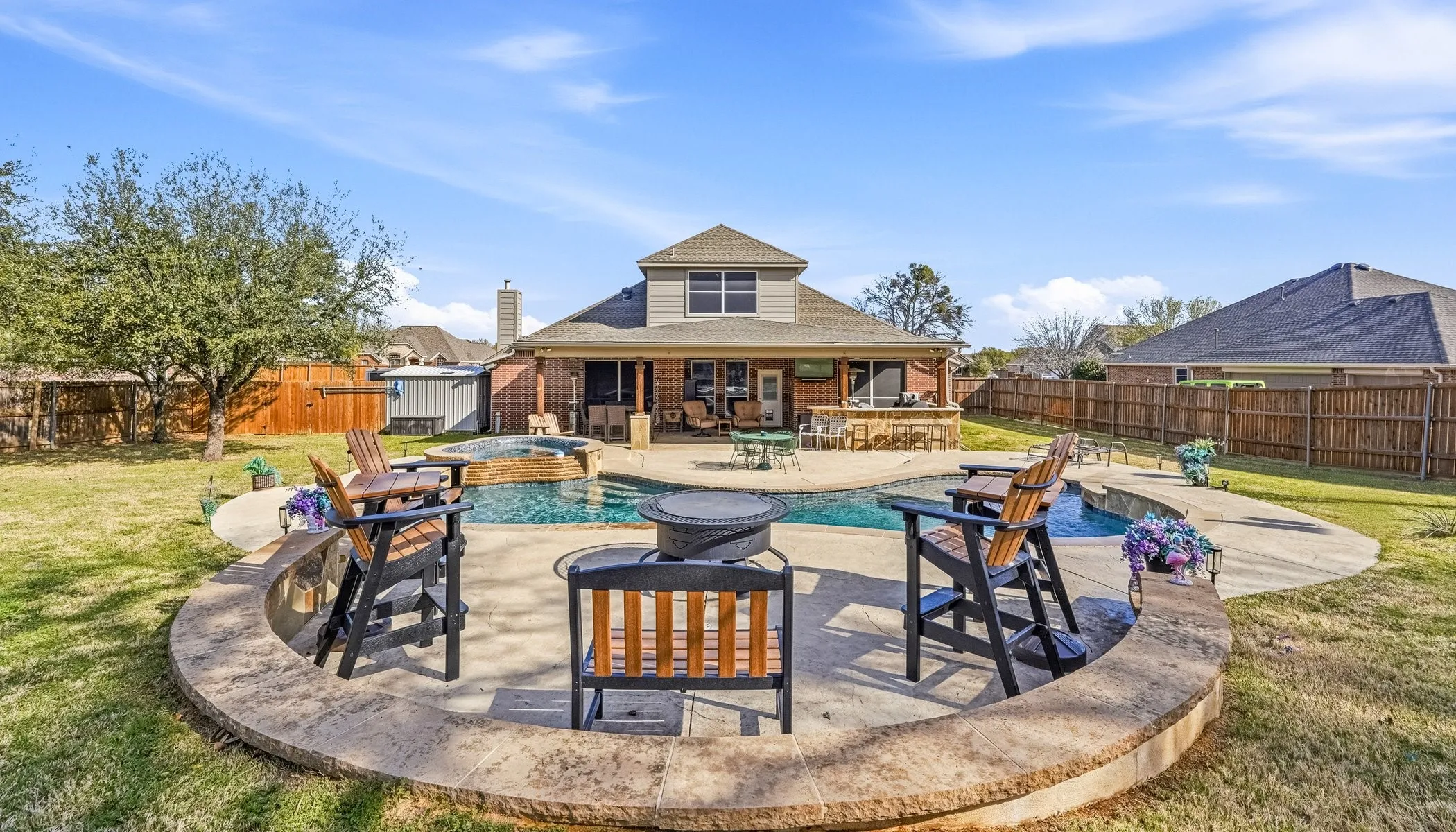 Integrated pool / hot tub featuring a patio area and a fenced backyard