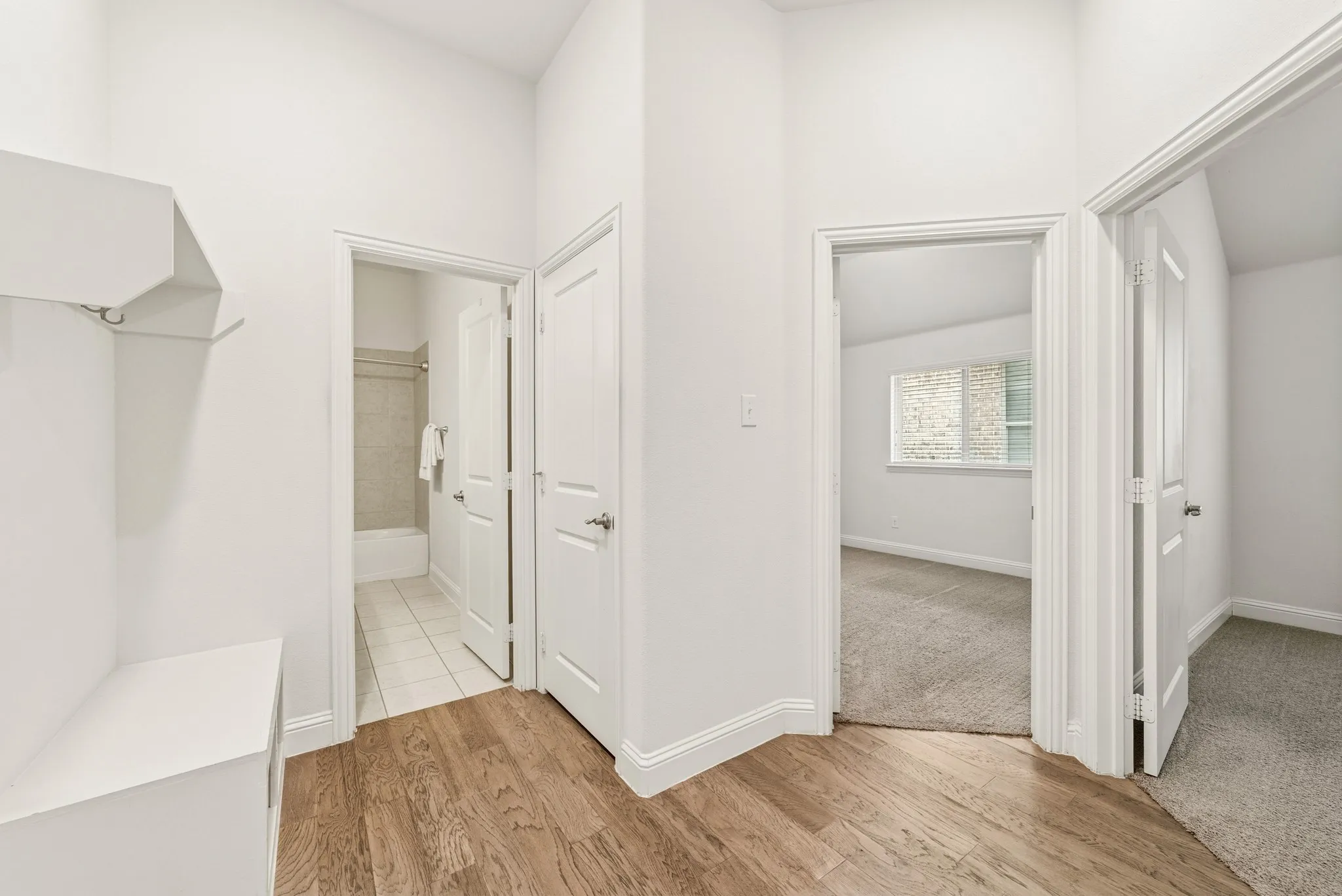 Spacious entry hall from garage featuring light wood finished floors