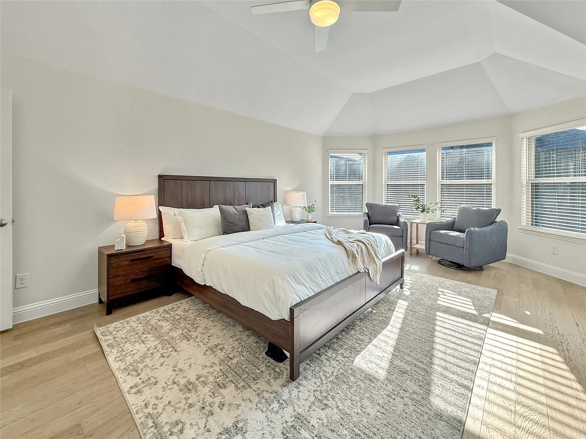 Bedroom featuring light wood-style flooring, a ceiling fan, and vaulted ceiling