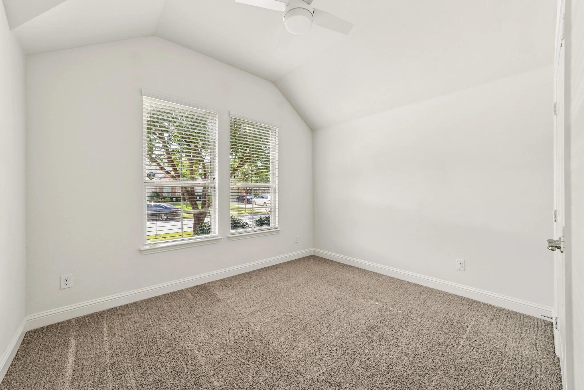 Bedroom featuring carpet flooring, lofted ceiling, and a ceiling fan