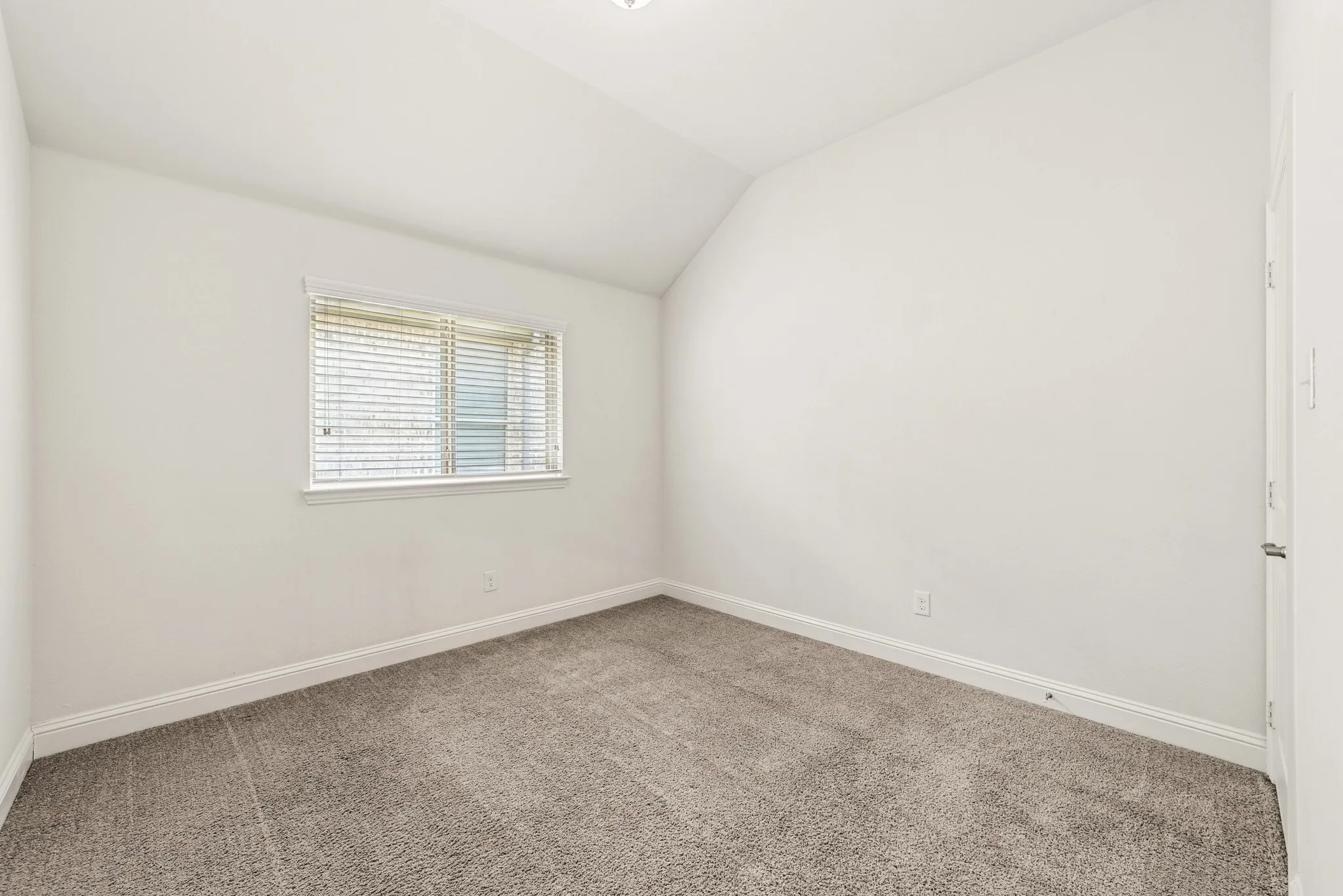 Bedroom with vaulted ceiling and carpet