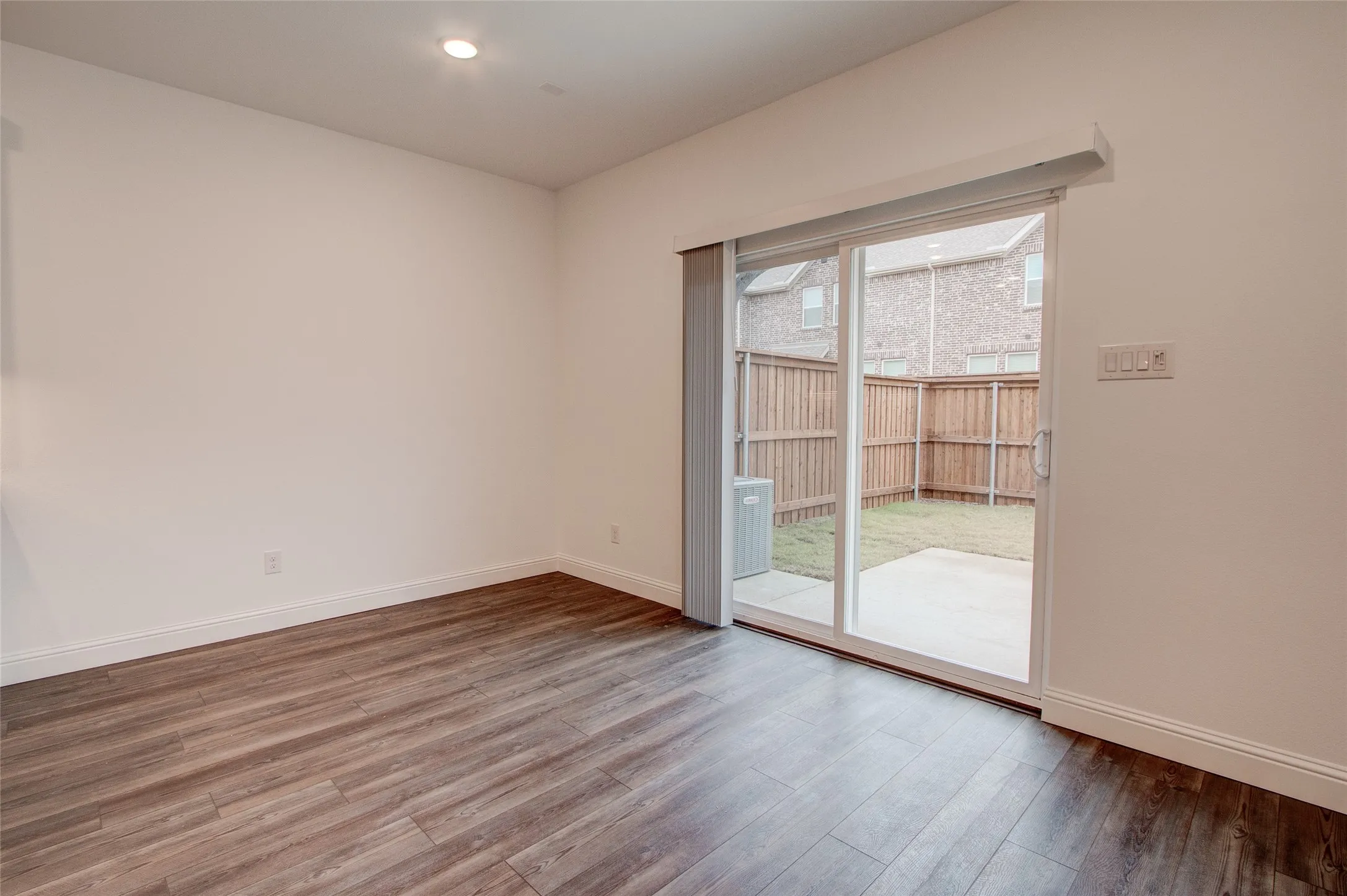Spare room with wood finished floors and recessed lighting