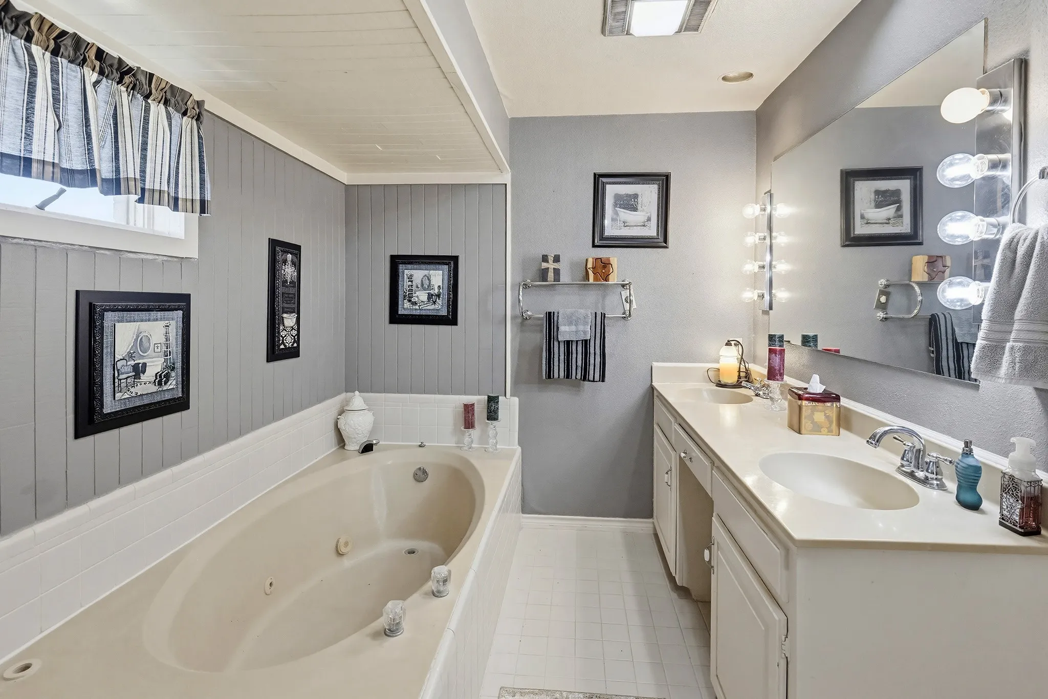 Full bathroom featuring double vanity and a whirlpool tub