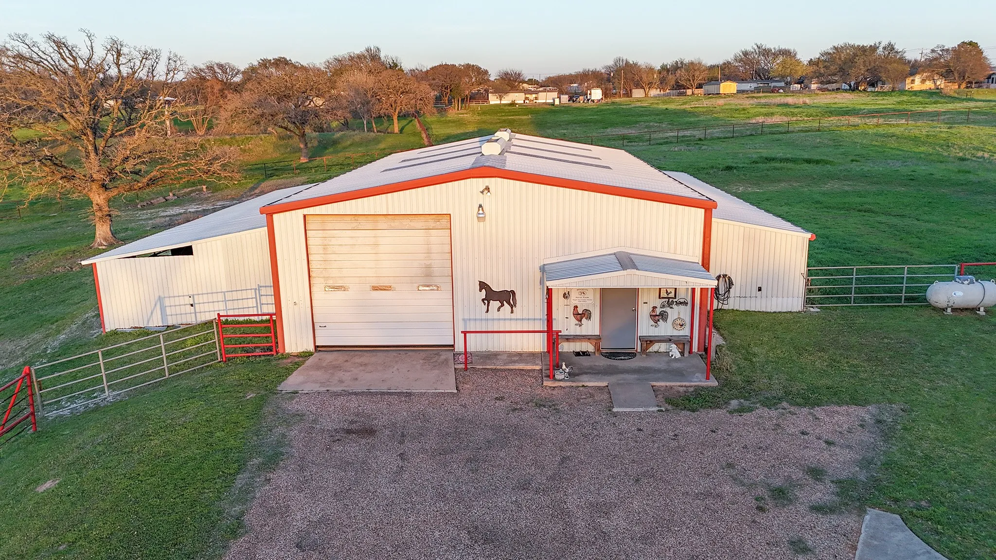 View of pole building featuring dirt driveway