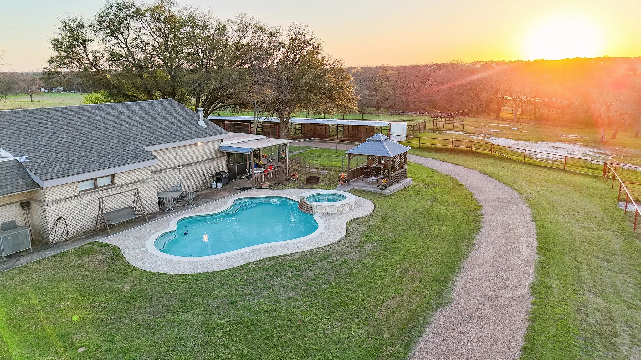 Relaxing pool / spa featuring a gazebo, a fenced backyard, and a patio area