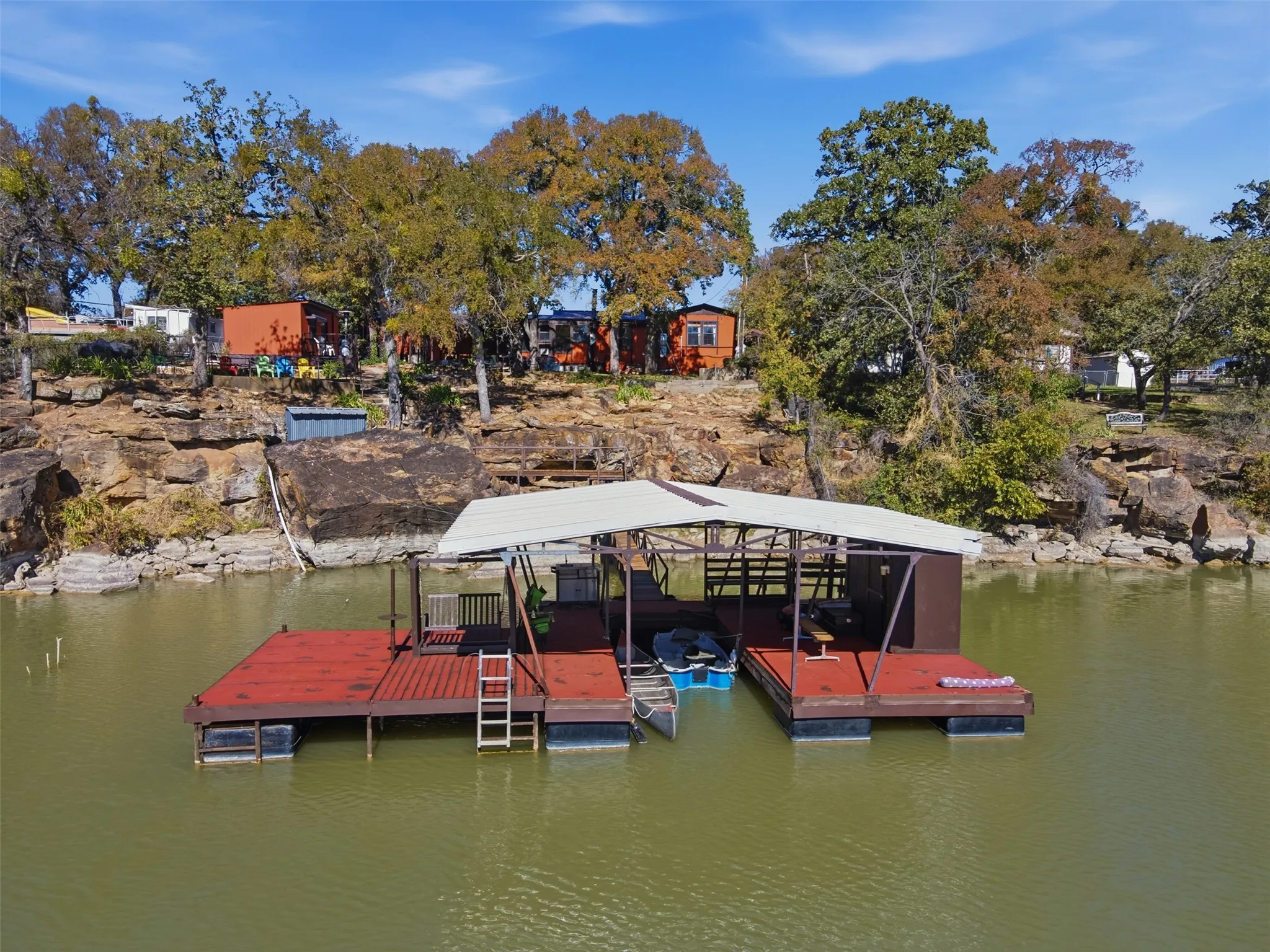 Waterfront view of the dock, swim deck and home beyond.