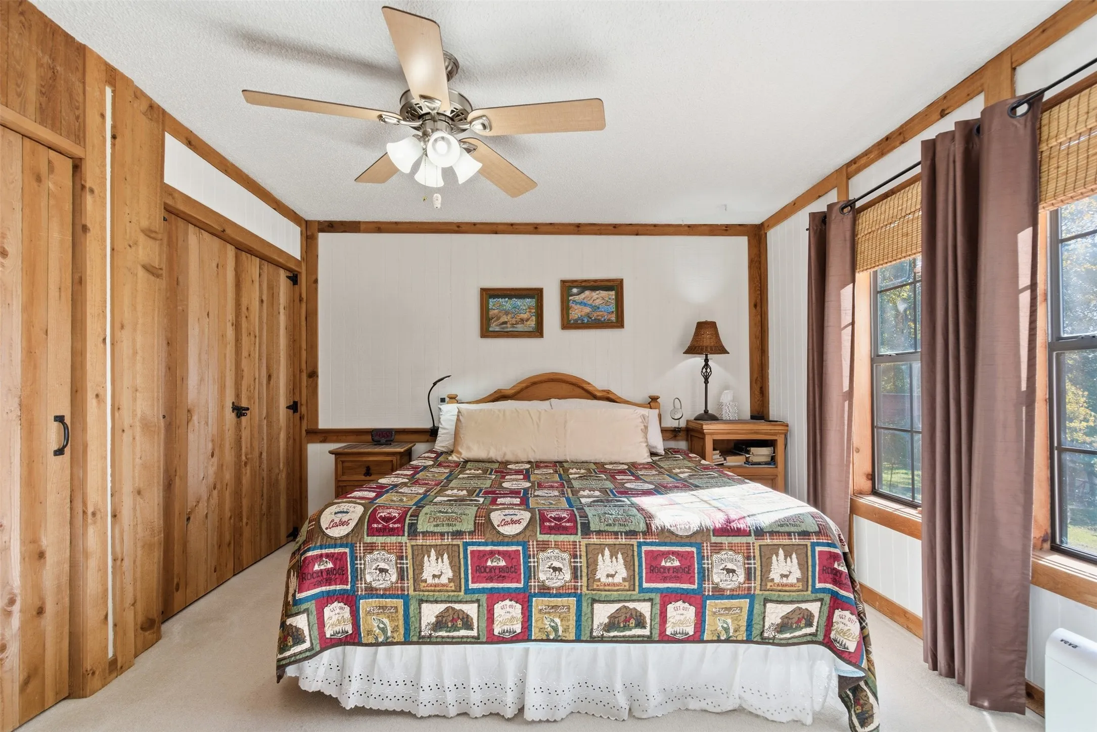 Comfortable bedroom with windows overlooking the lake and an en-suite bathroom.