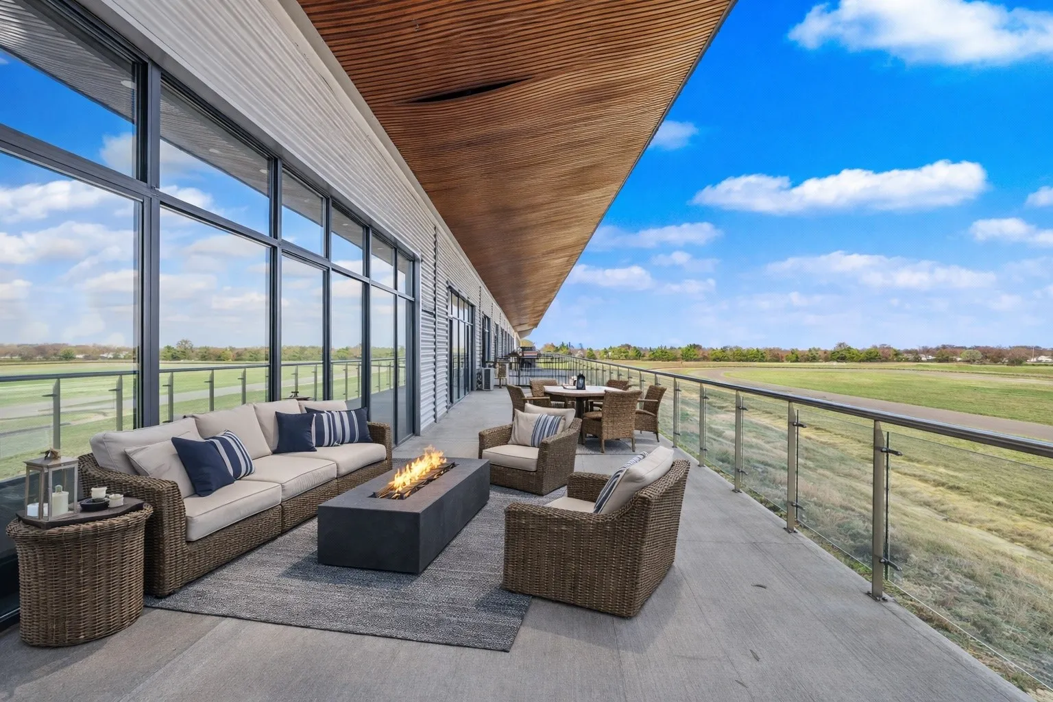 View of patio featuring golf course view, outdoor lounge area, and an outdoor fire pit