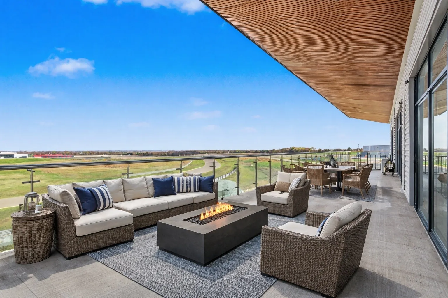 View of patio / terrace with an outdoor living / dining area and an outdoor fire pit