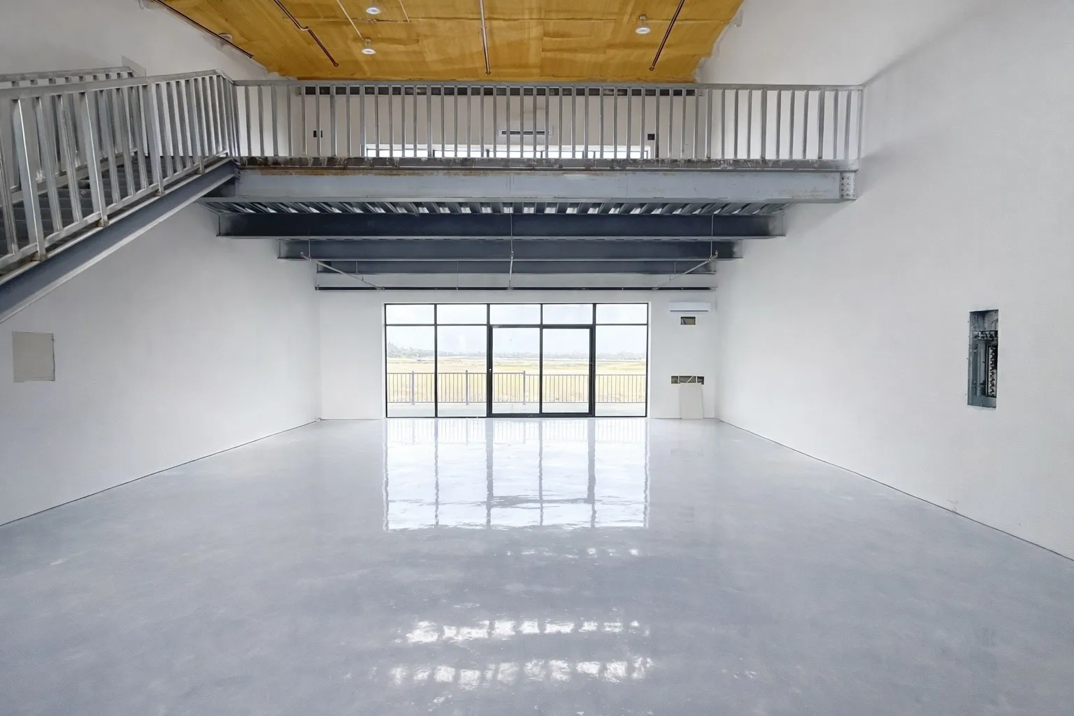 Unfurnished living room featuring finished concrete flooring, a high wood ceiling, and electric panel