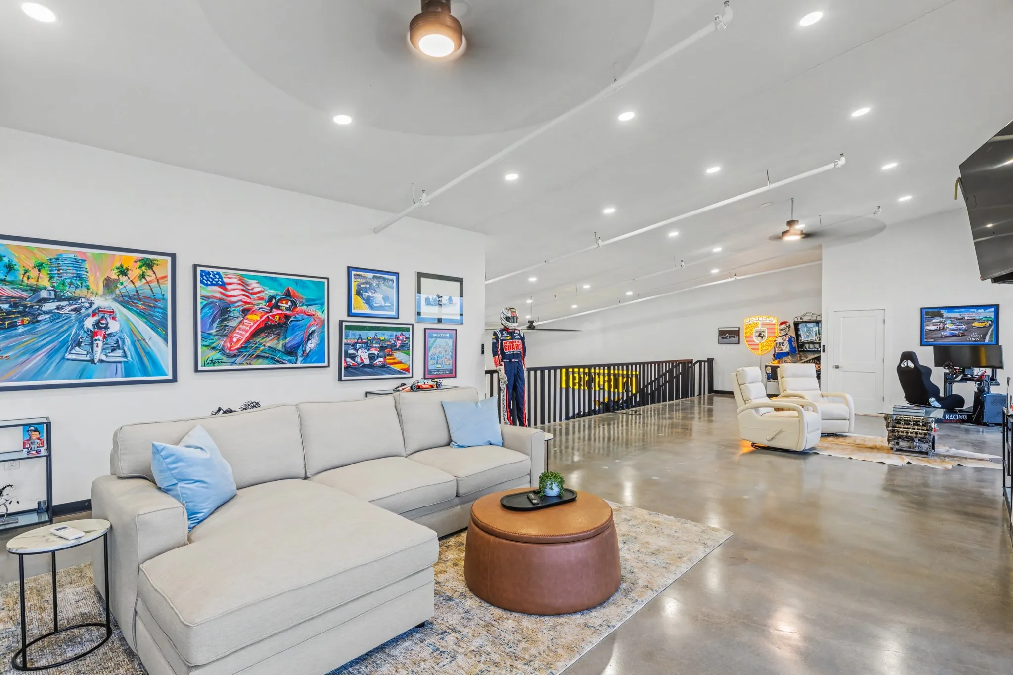 Living area with a ceiling fan, concrete floors, recessed lighting, and a high ceiling