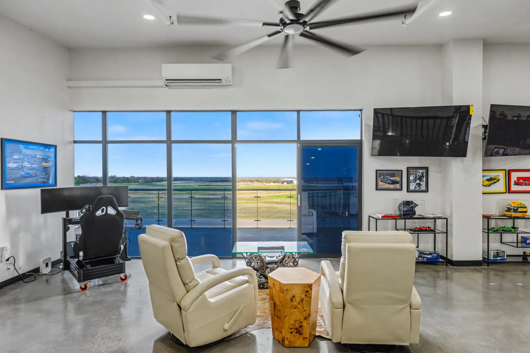 Living room featuring finished concrete flooring, a high ceiling, recessed lighting, and a ceiling fan