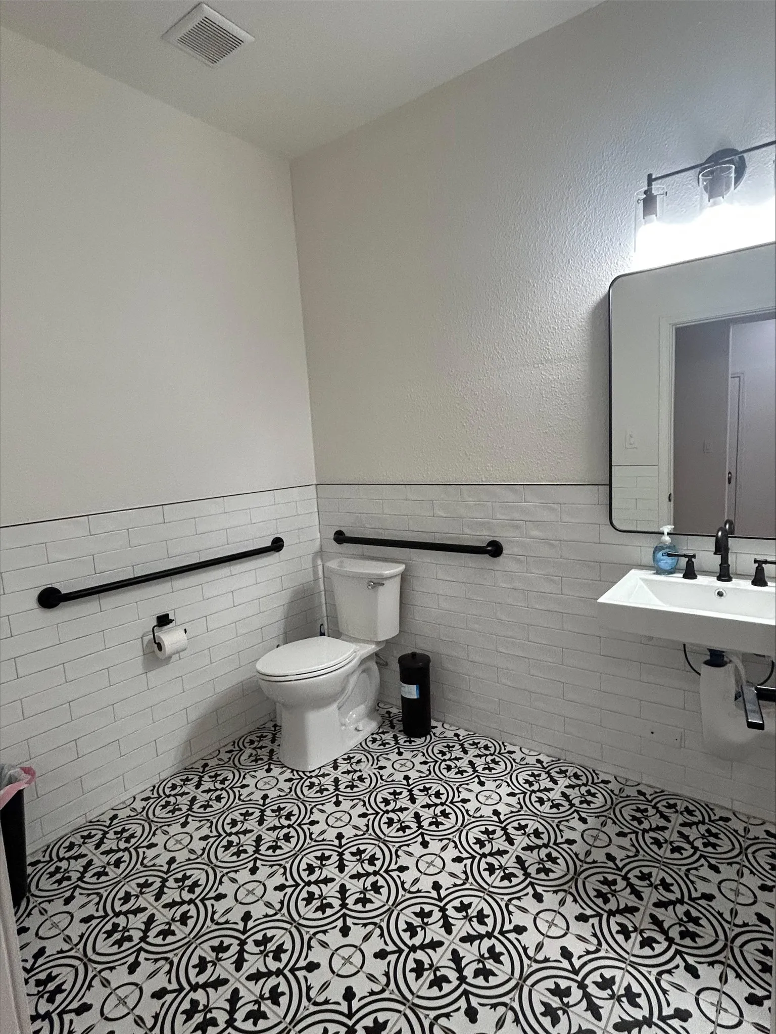 Bathroom featuring tile patterned flooring, tile walls, and toilet
