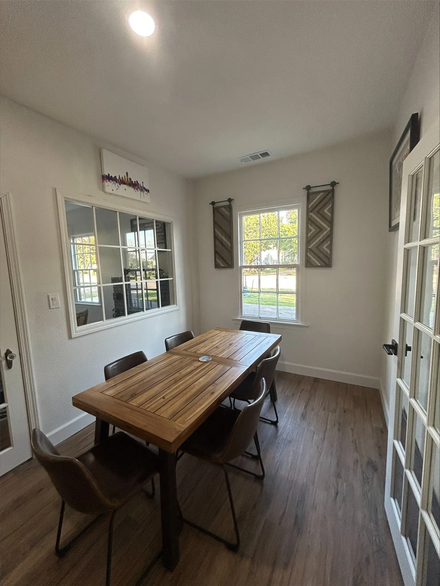 Dining space with dark hardwood / wood-style flooring