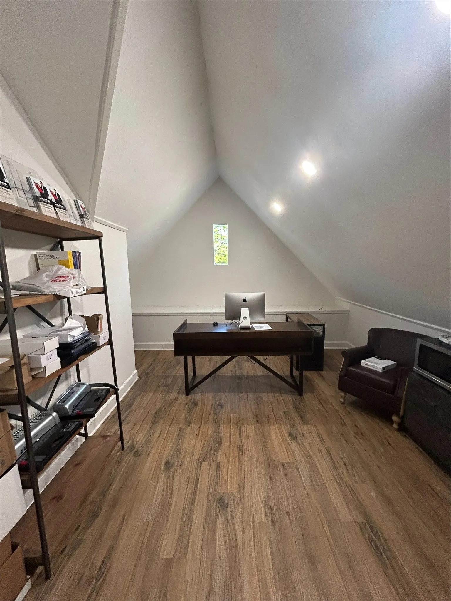Office area featuring lofted ceiling and dark hardwood / wood-style flooring