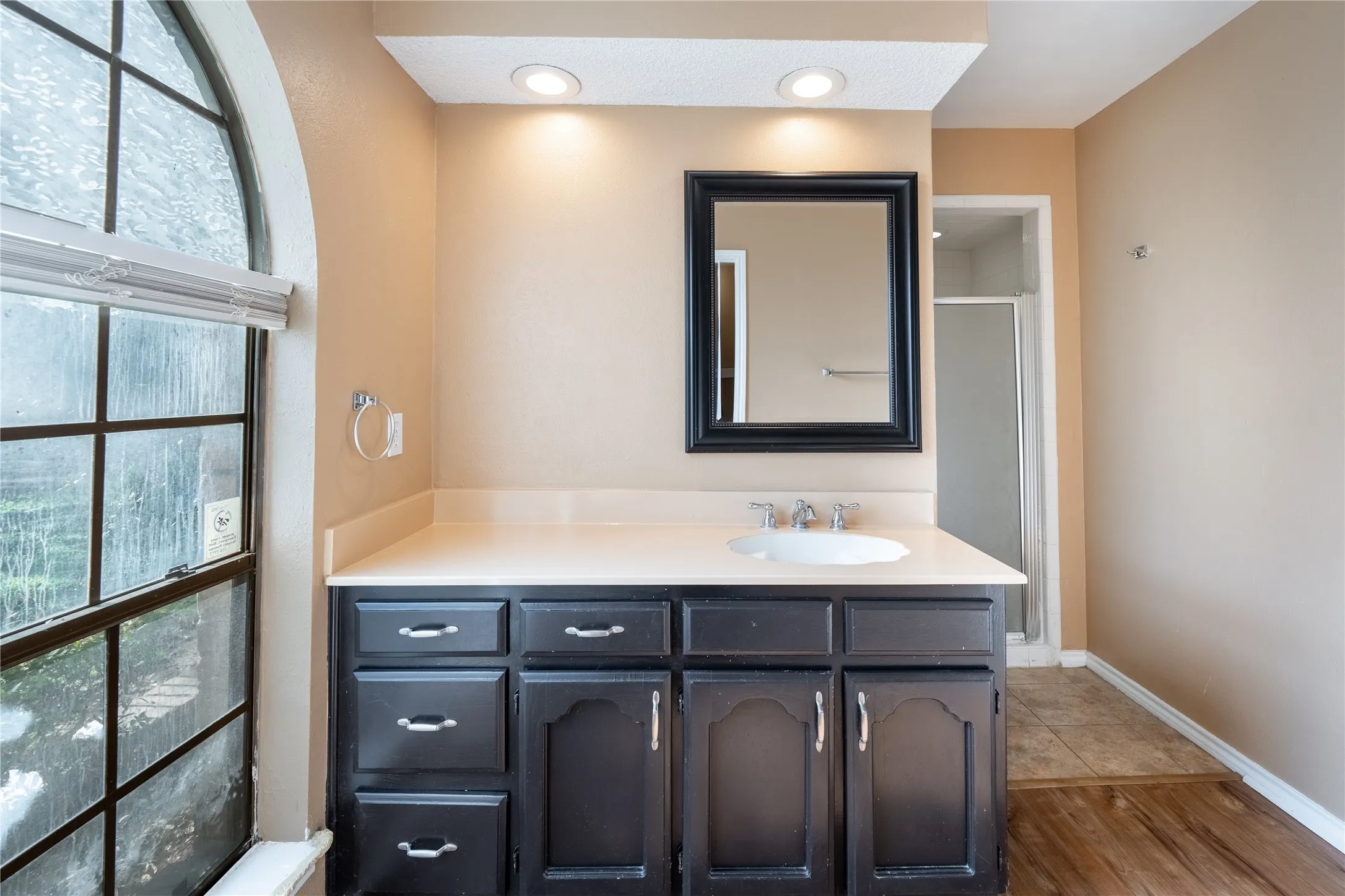 Bathroom with recessed lighting, vanity, baseboards, and wood finished floors