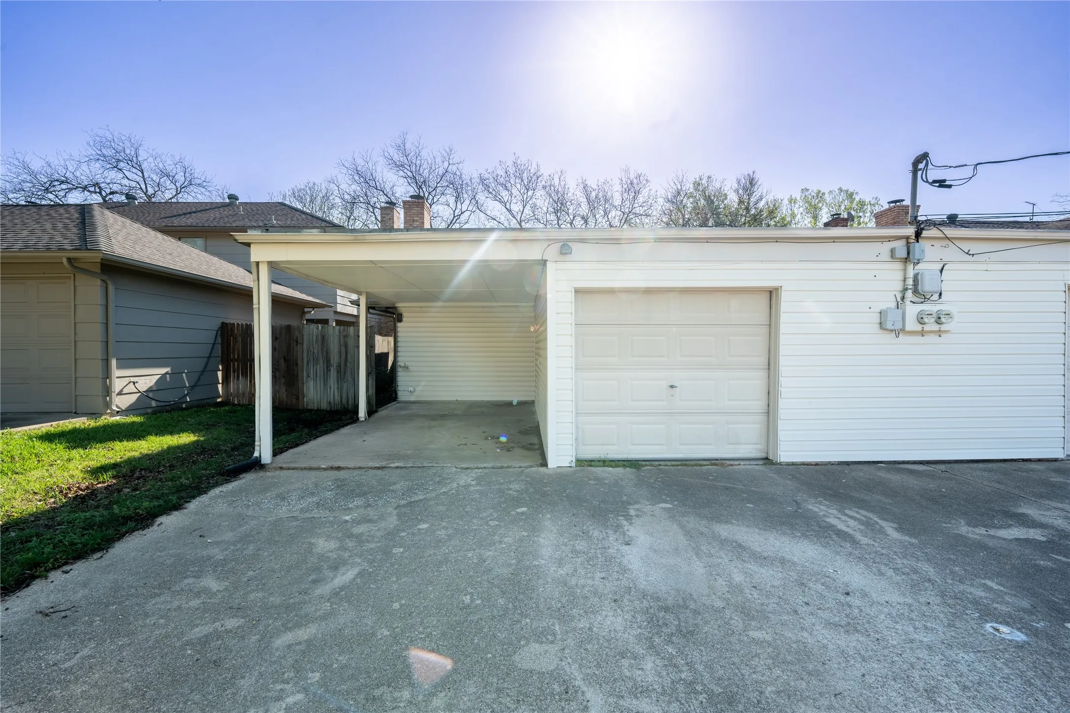 Garage with aphalt driveway and fence