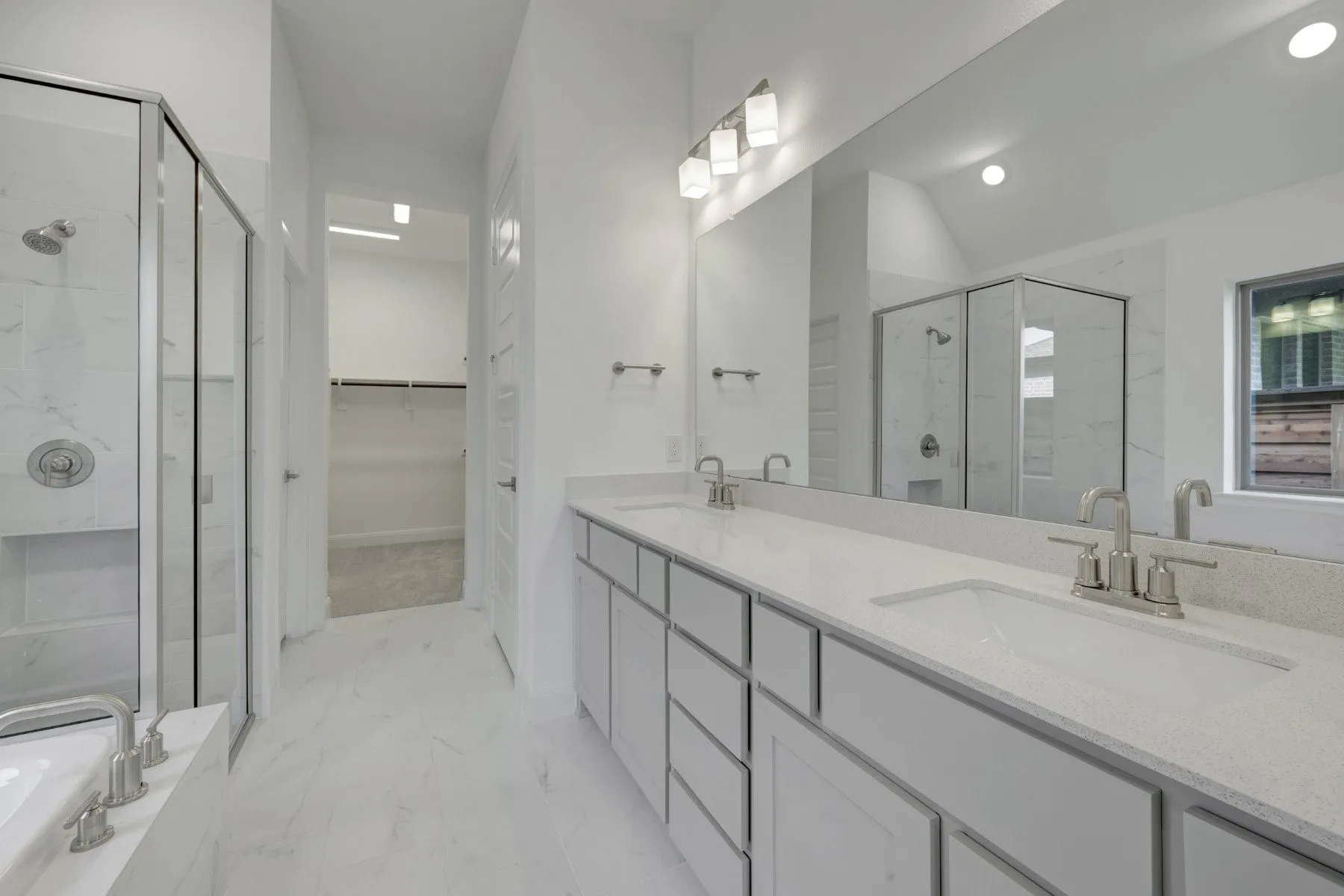 Double vanity with undermount sinks, quartz-finish countertop, and brushed nickel fixtures