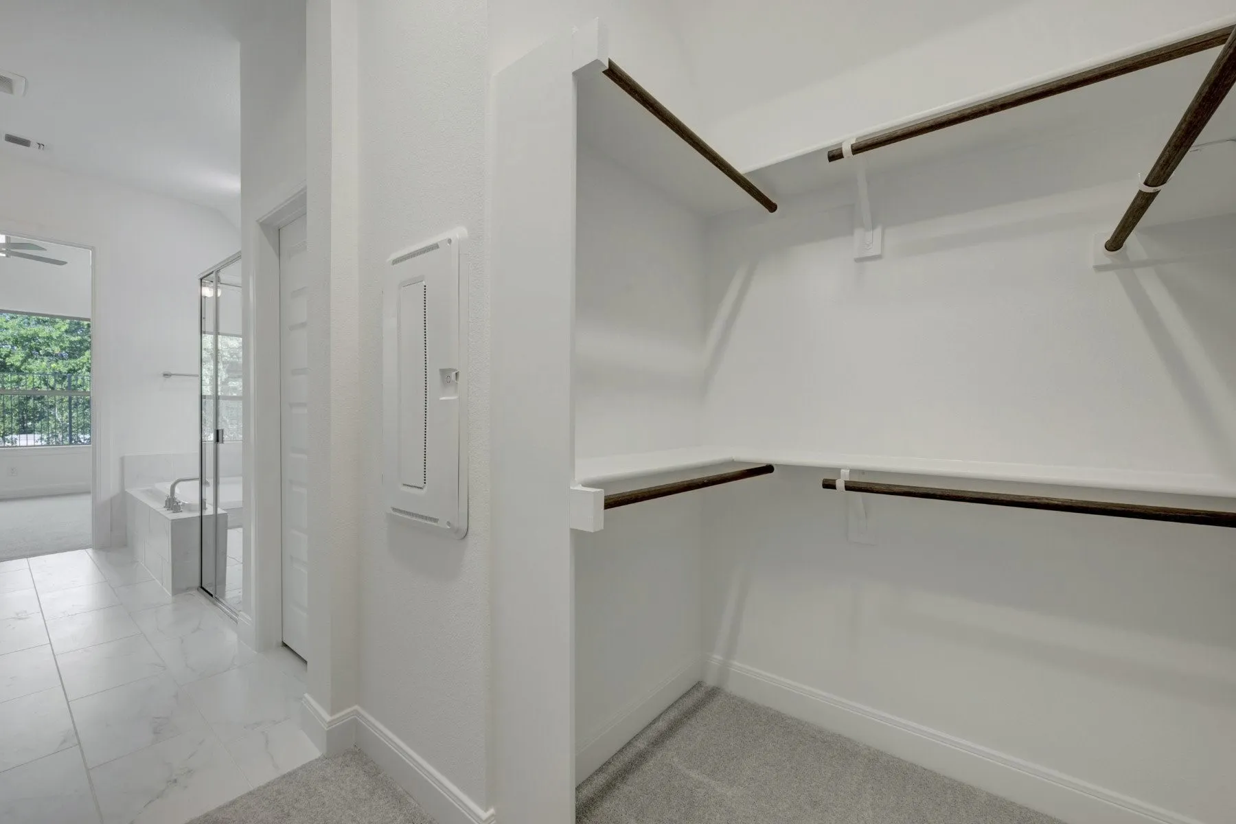Walk-in closet with carpet flooring and shelving