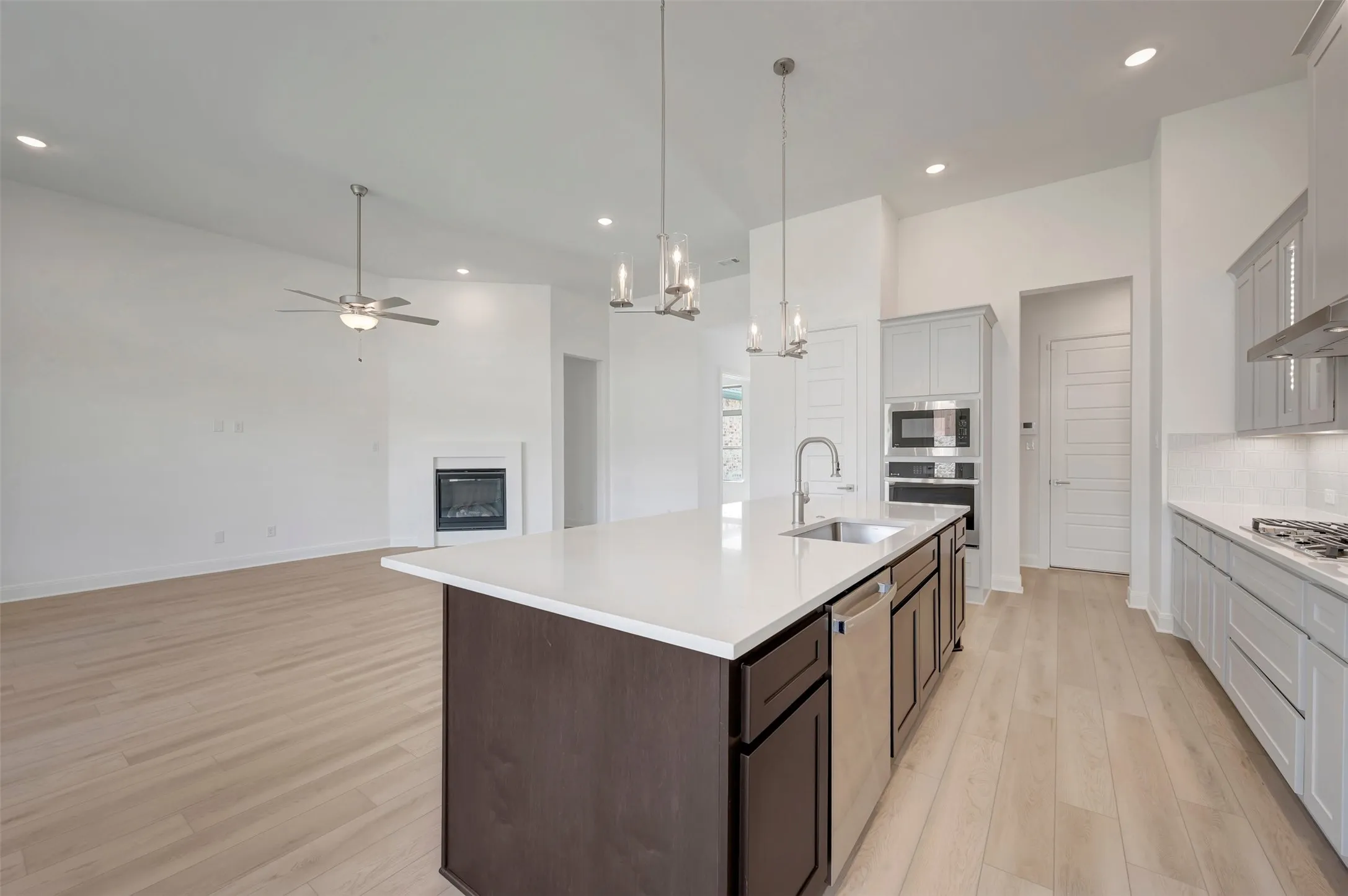 Kitchen island with an undermount sink, gooseneck faucet, and integrated dishwasher