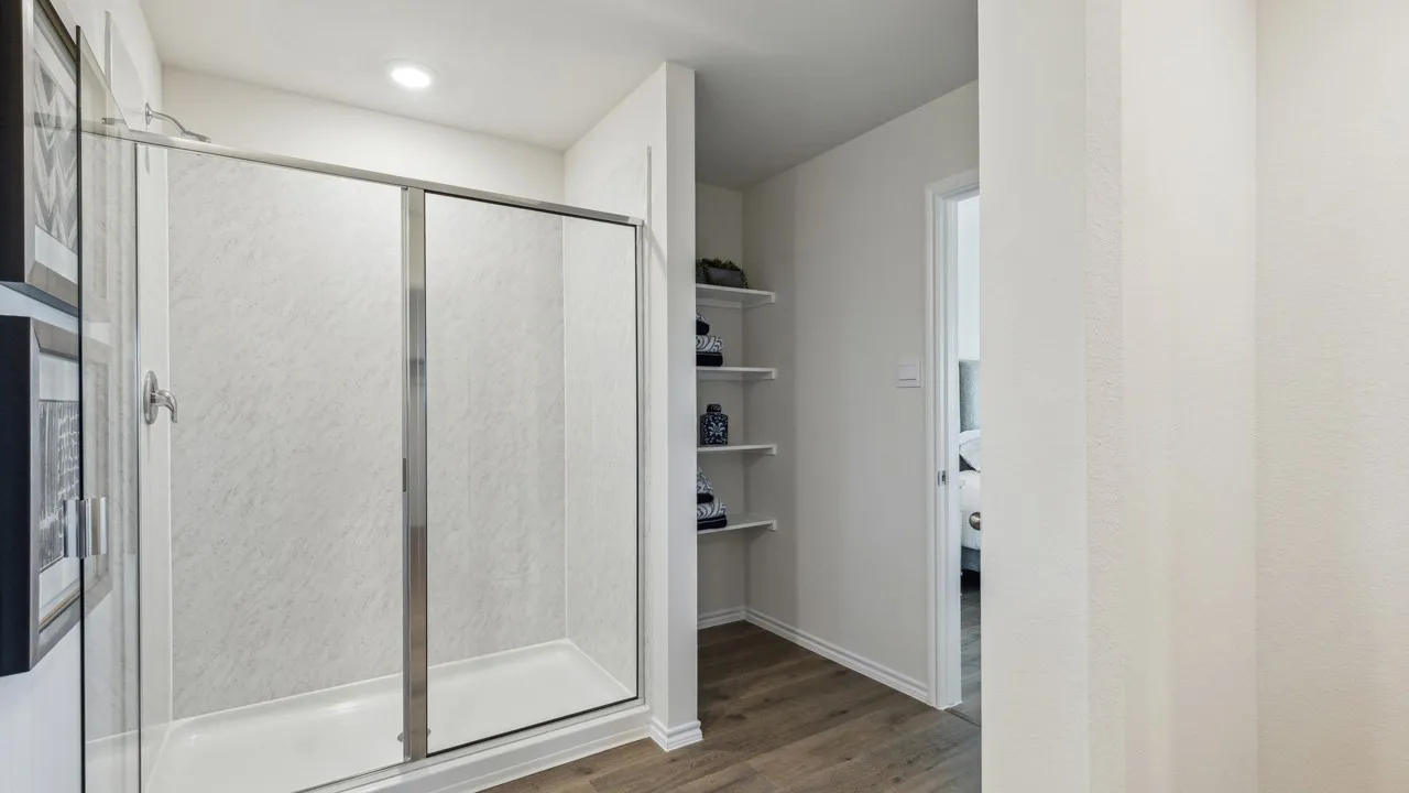 Bathroom featuring a shower stall, dark wood finished floors, and connected bathroom