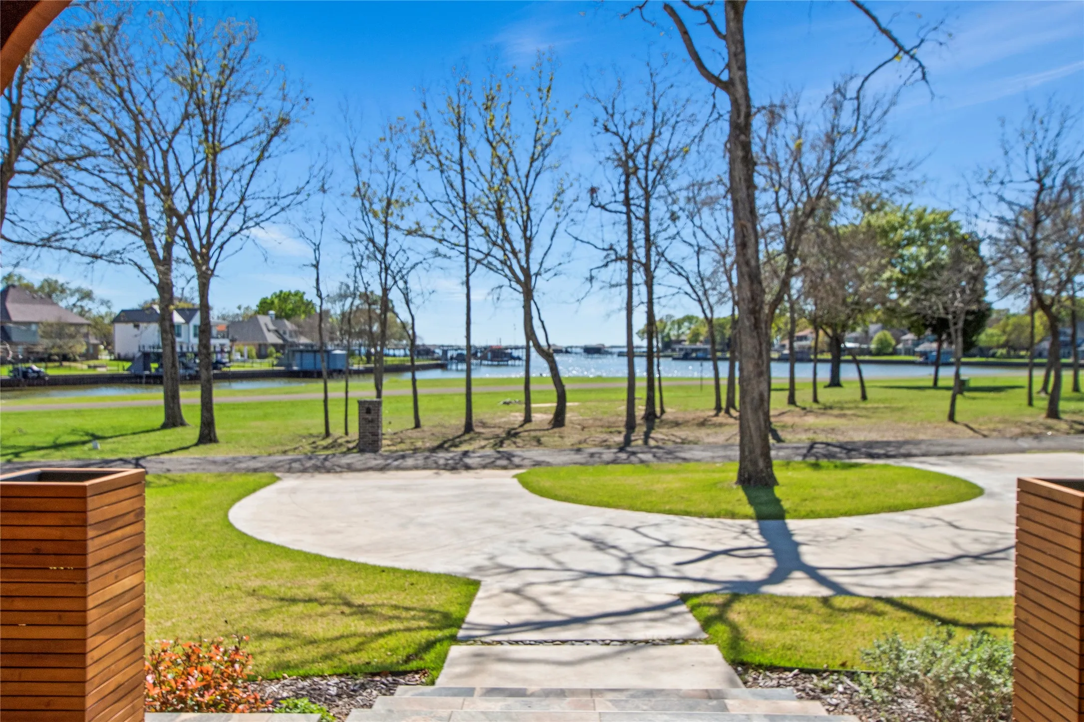 Front porch view overlooks water across the street, with protected land that cannot be developed—ensuring the view remains unobstructed.