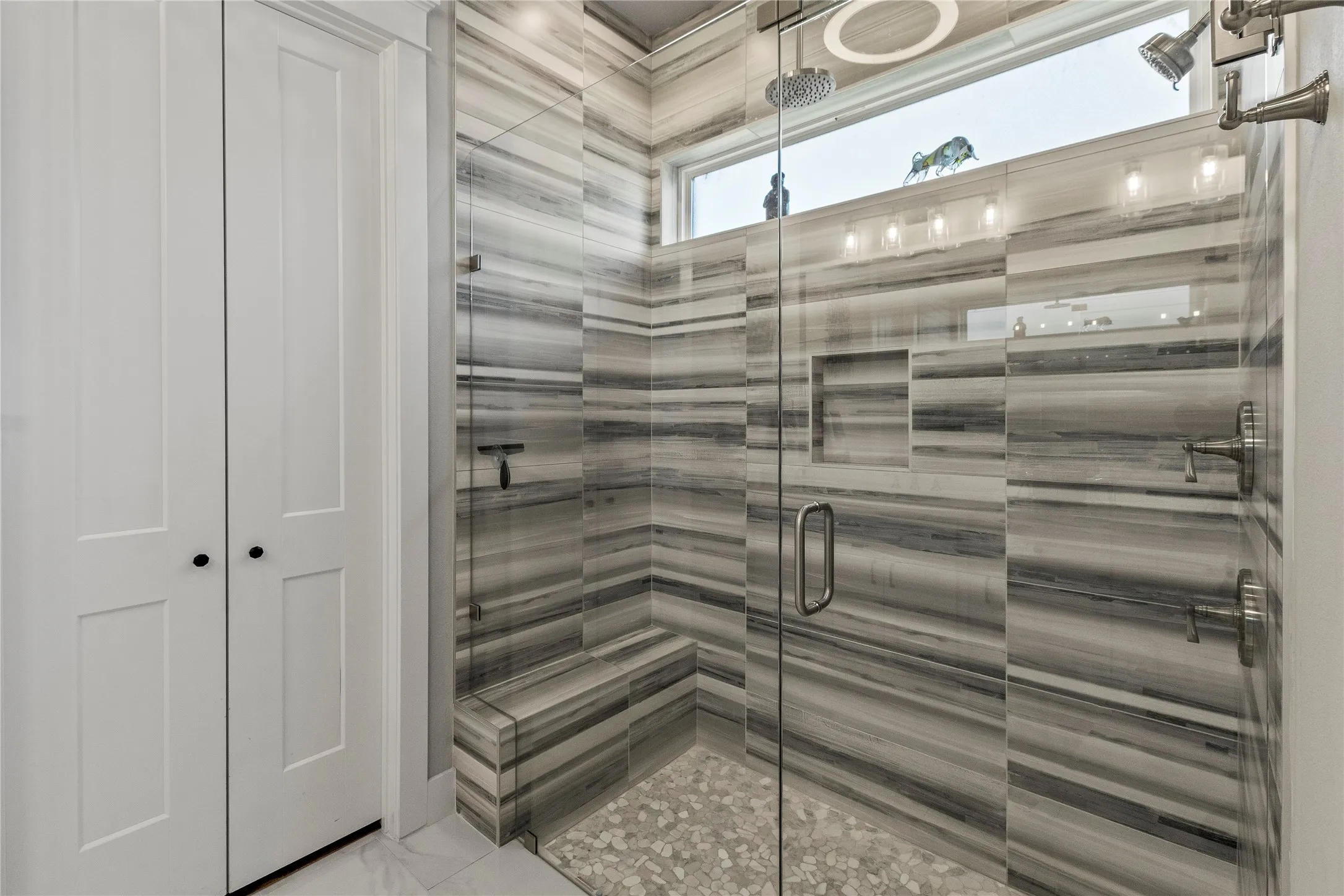 Primary bath shower with rain and regular shower heads.