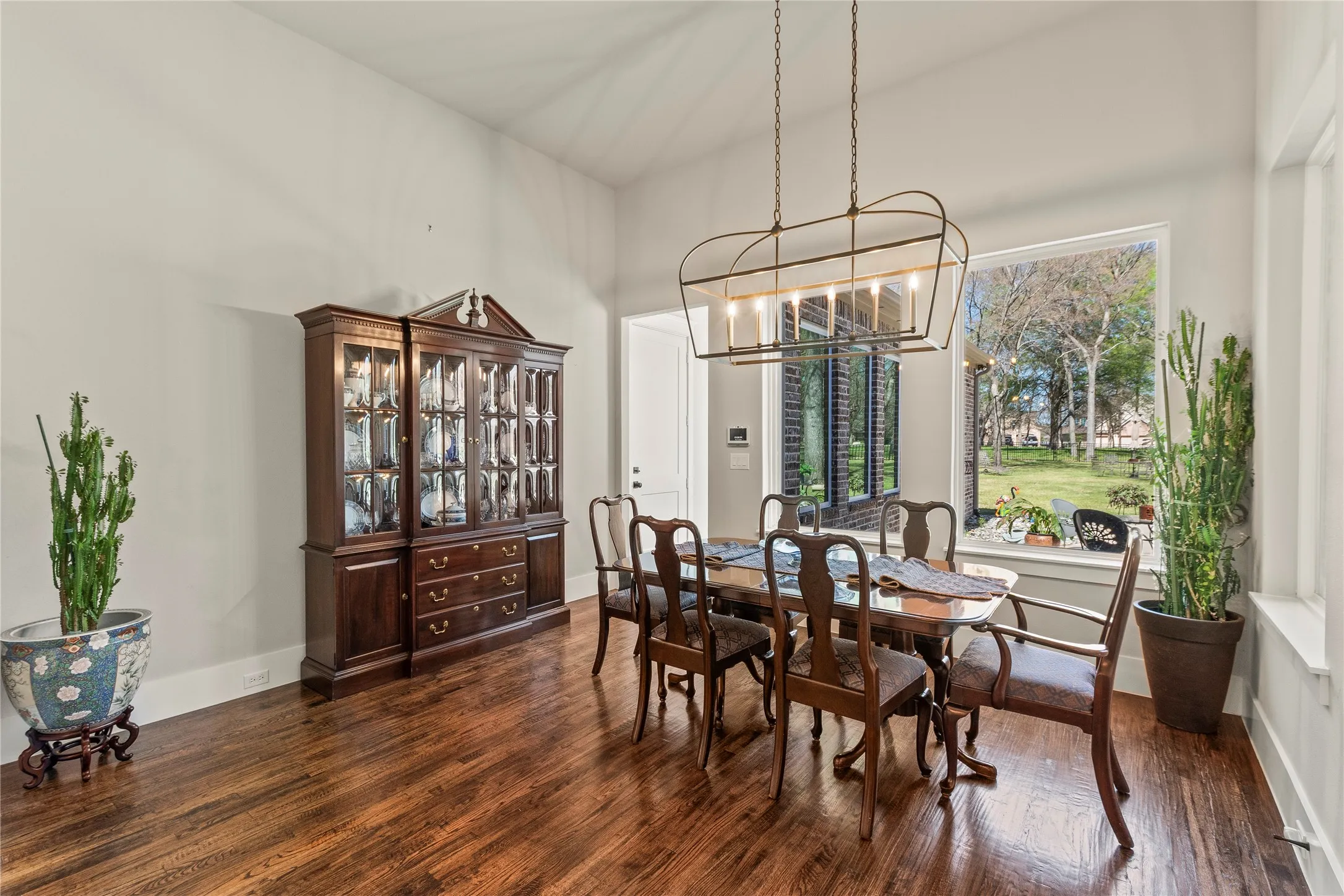 Spacious dining area with windows overlooking back yard.