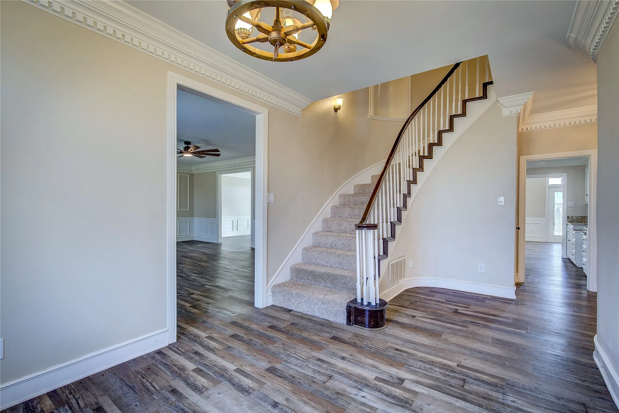 Grand entry foyer with curved wall and staircase, extensive dentil molding
