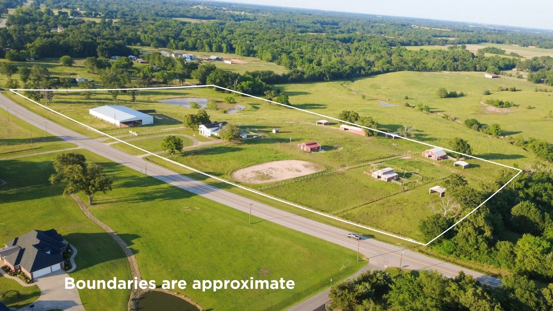 20 acres with stately colonial home, three horse barns, an arena, large pond, workshop- an equestrian's dream!