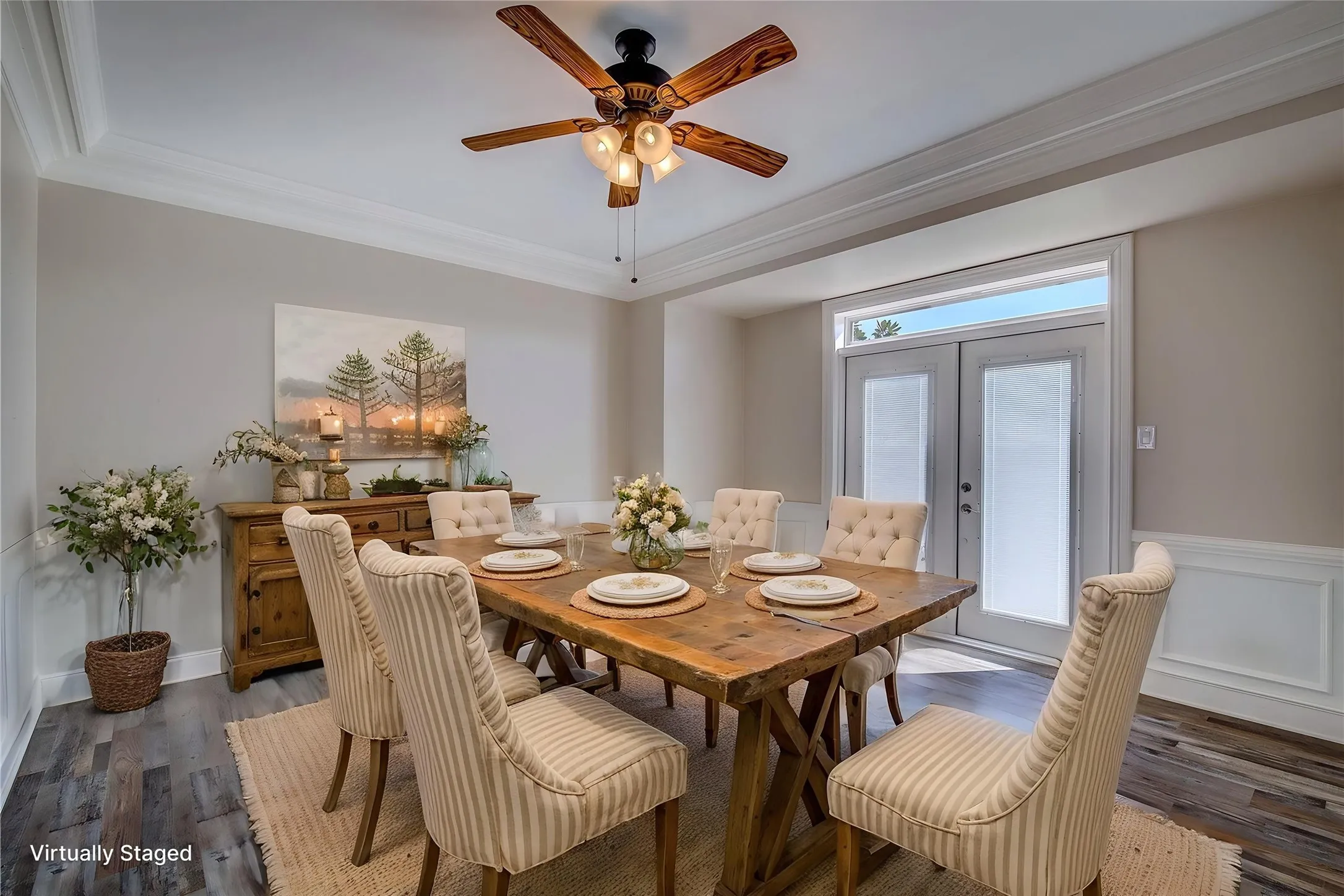 Formal dining has french doors to back porch and pool area, trey ceiling, crown molding, wainscoting, 6-inch baseboards