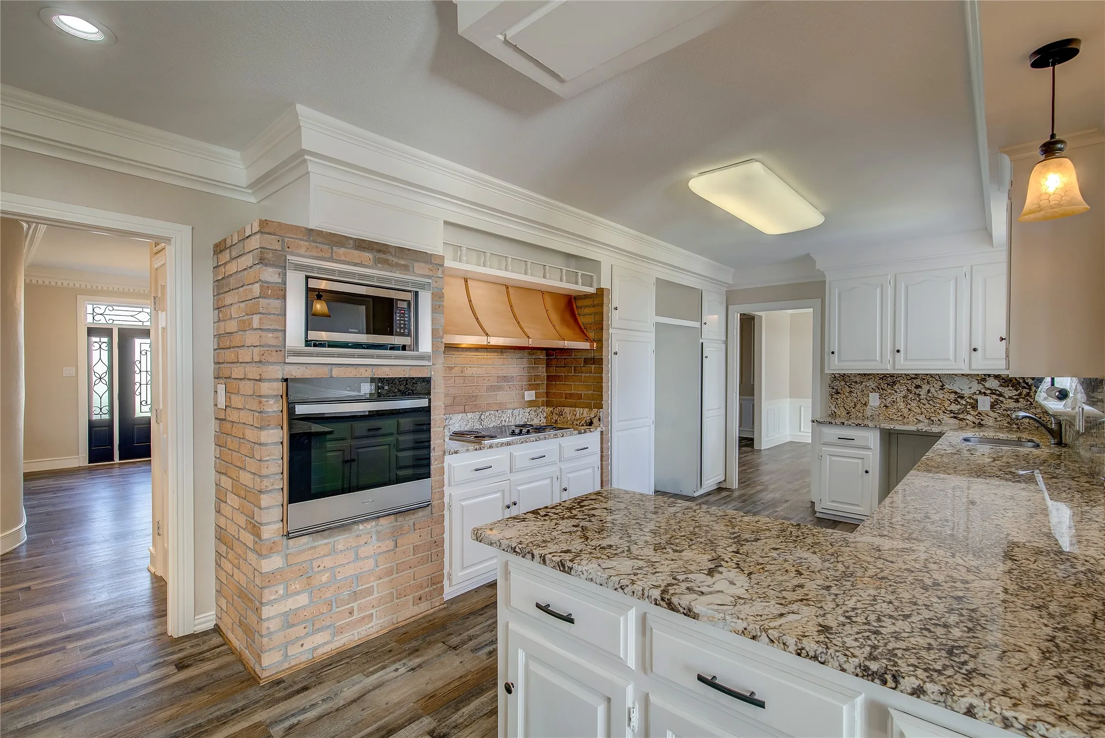 View from breakfast bar; double pantry cabinets, tons of cabinet space