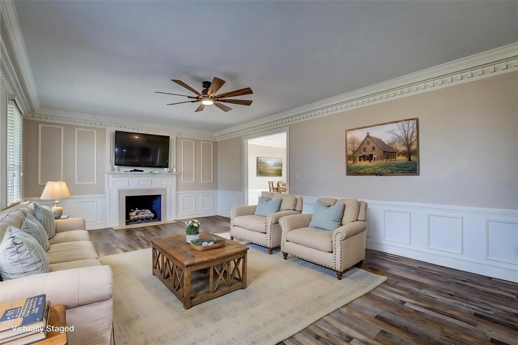 Living room off of entry has fireplace, dentil molding, wainscoting, 6-inch baseboards- the quality is unmatched
