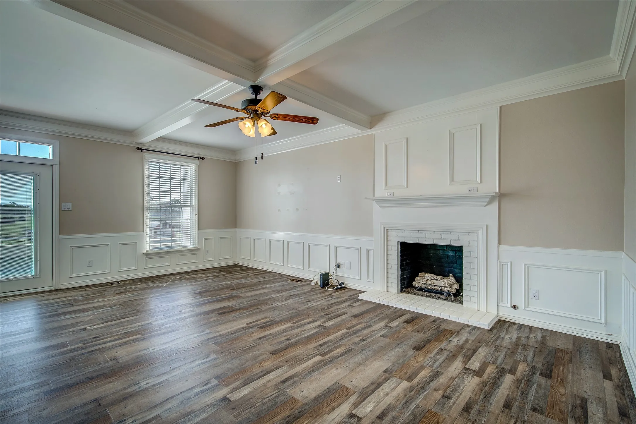 Great room has french doors that open onto the pool area, brick fireplace with mantel, lots of molding details!