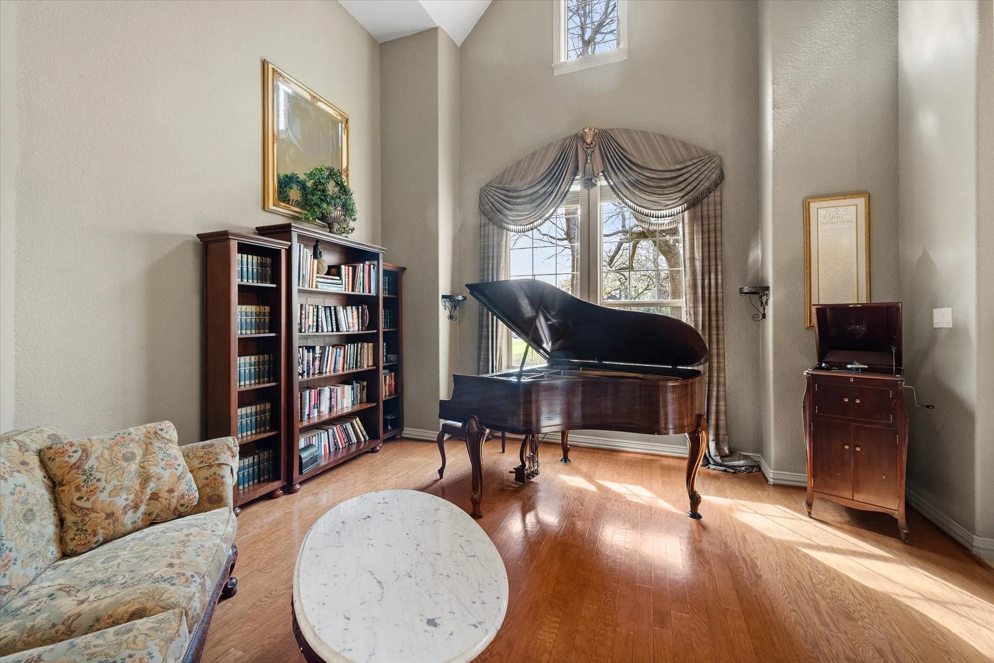 Family Room with wood finished floors and a high ceiling