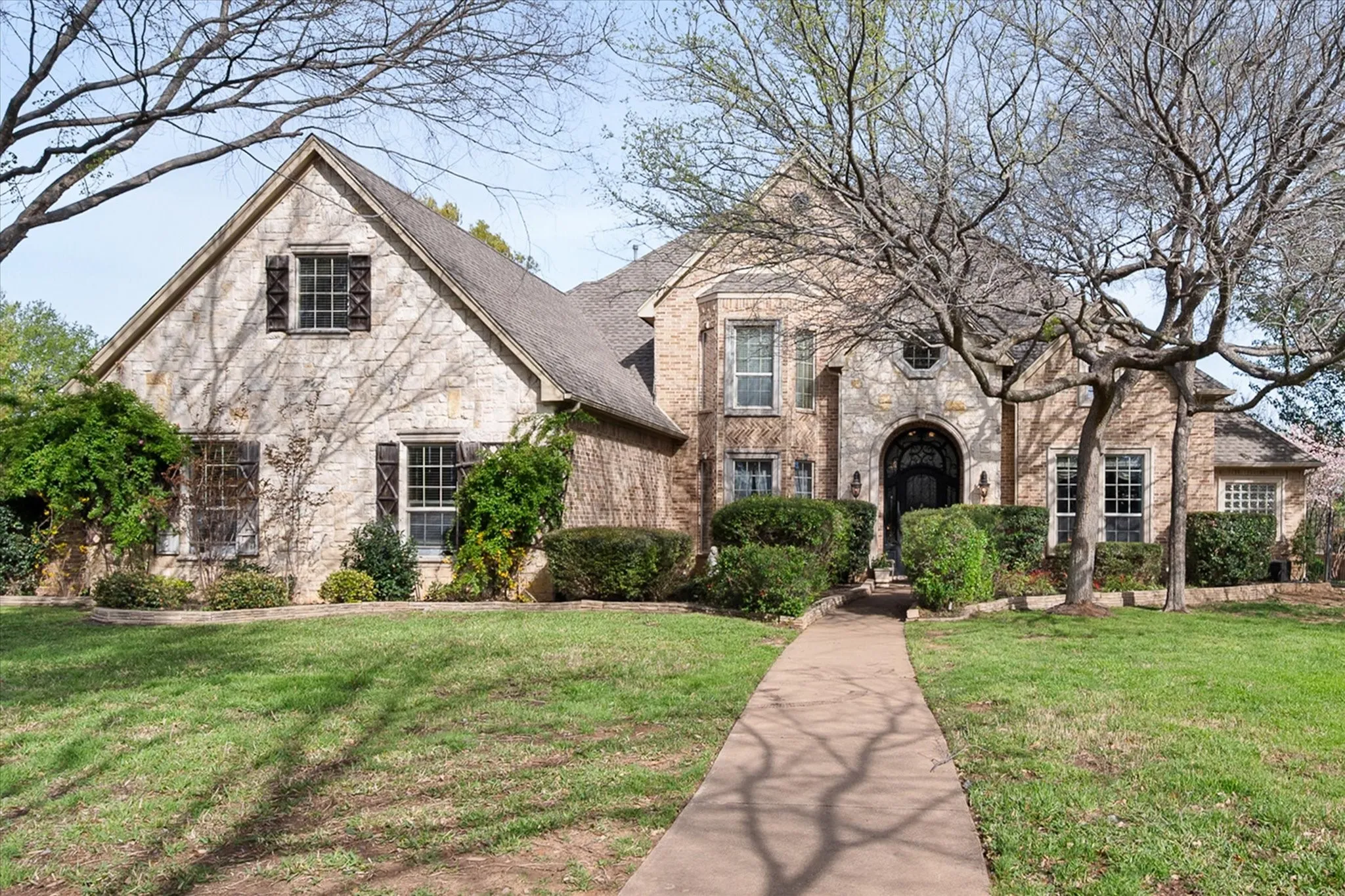 View of front of home with a front yard and brick siding