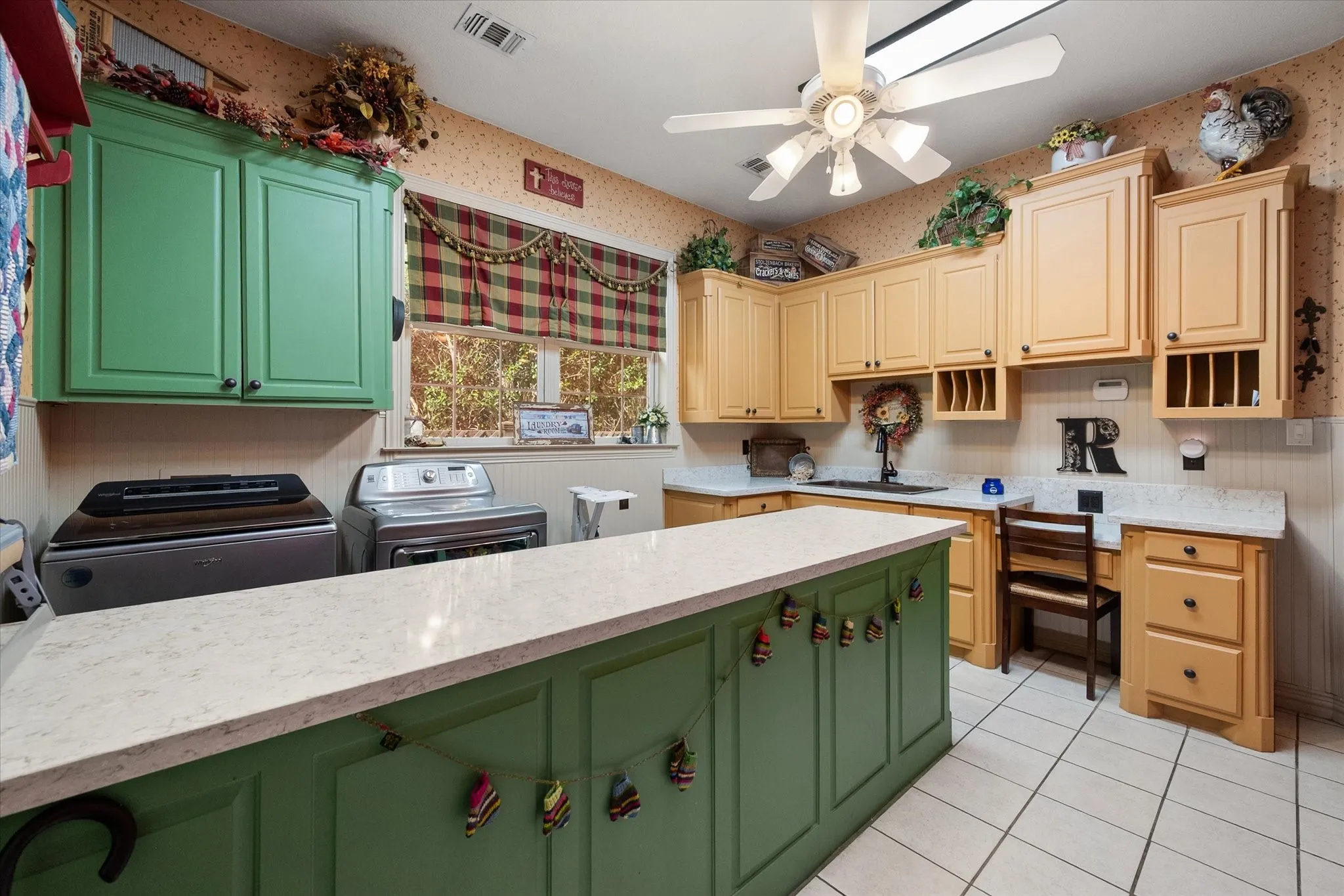 Utility room with dual tone cabinetry & a ceiling fan!