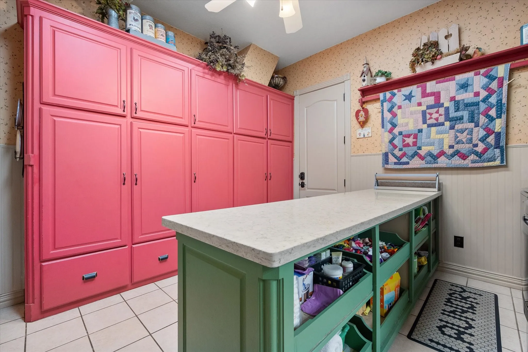 Utility featuring wainscoting, wallpapered walls, light countertops, light tile patterned floors, and ceiling fan
